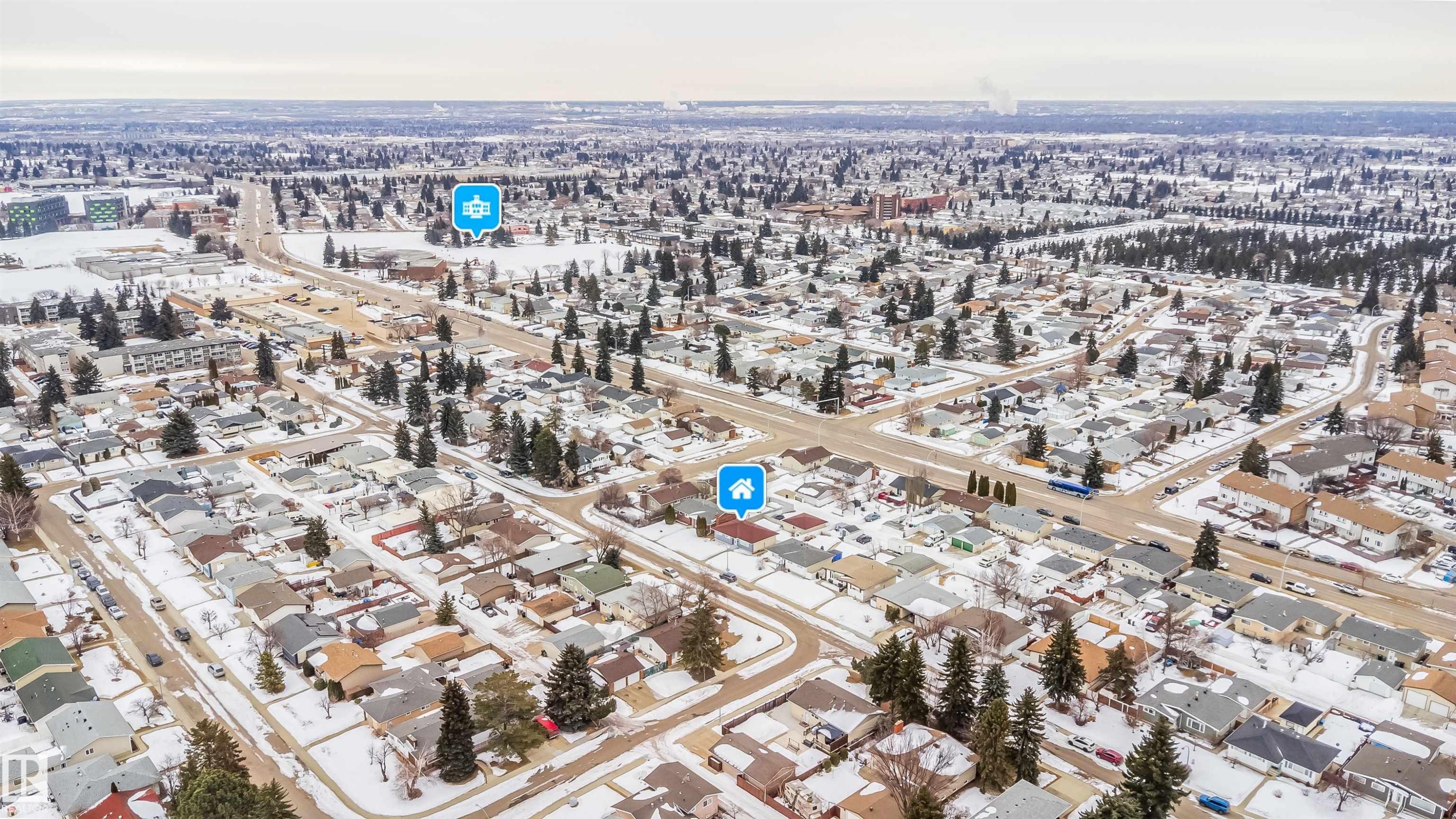 Aerial view of the surrounding neighbourhood showing residential properties with snow-covered roofs and grounds, and mature trees - 7911 145 Avenue Nw, Edmonton, AB - Outdoor With View