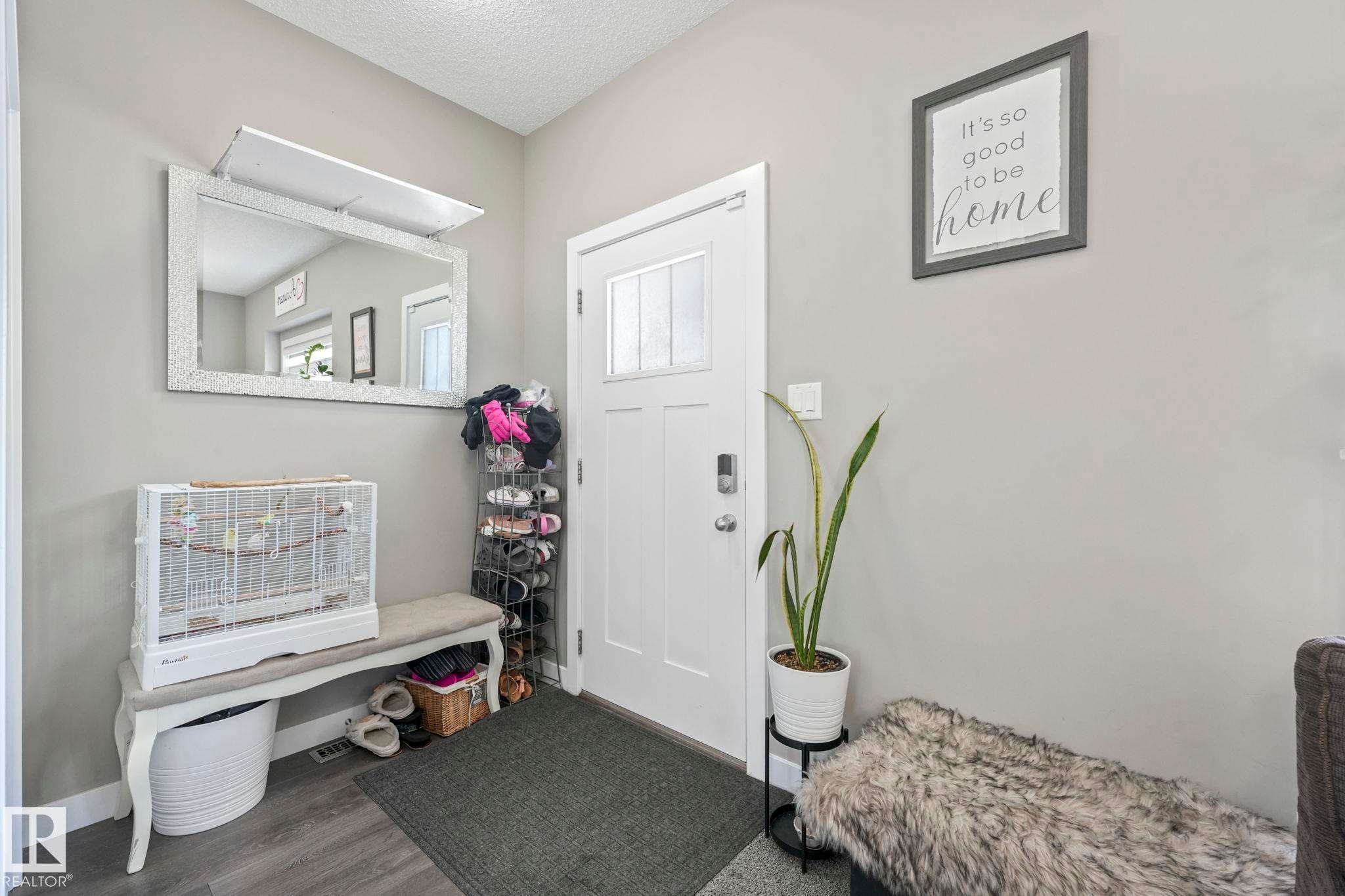 Foyer featuring dark wood-type flooring and a textured ceiling - 2428 Wonnacott Crest, Edmonton, AB - Indoor Photo Showing Other Room