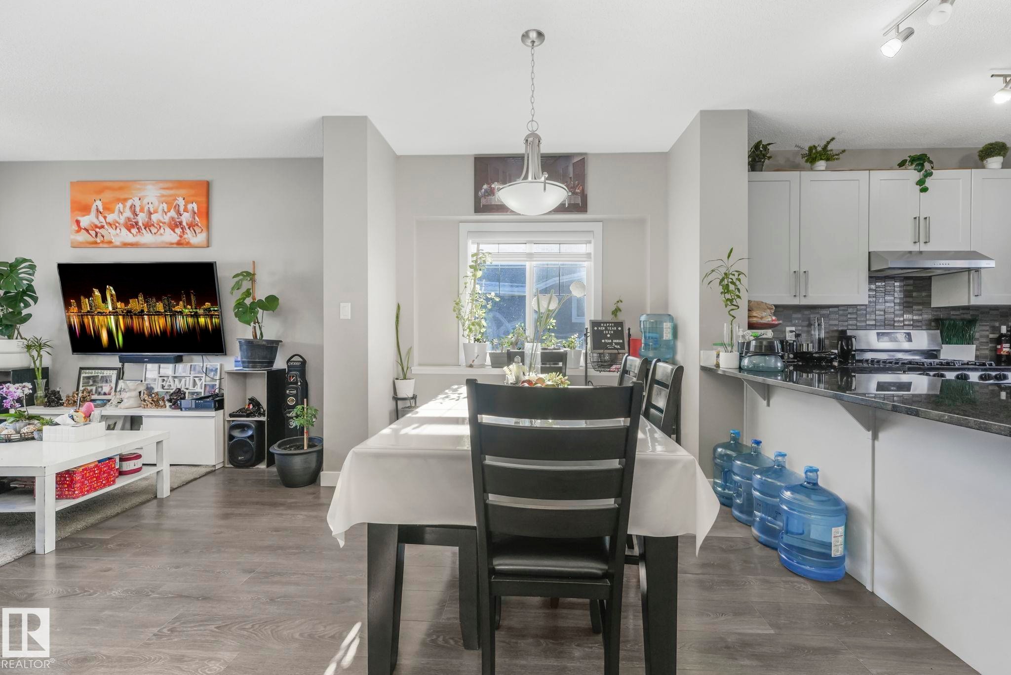 Dining space with dark wood-style floors and rail lighting - 2428 Wonnacott Crest, Edmonton, AB - Indoor