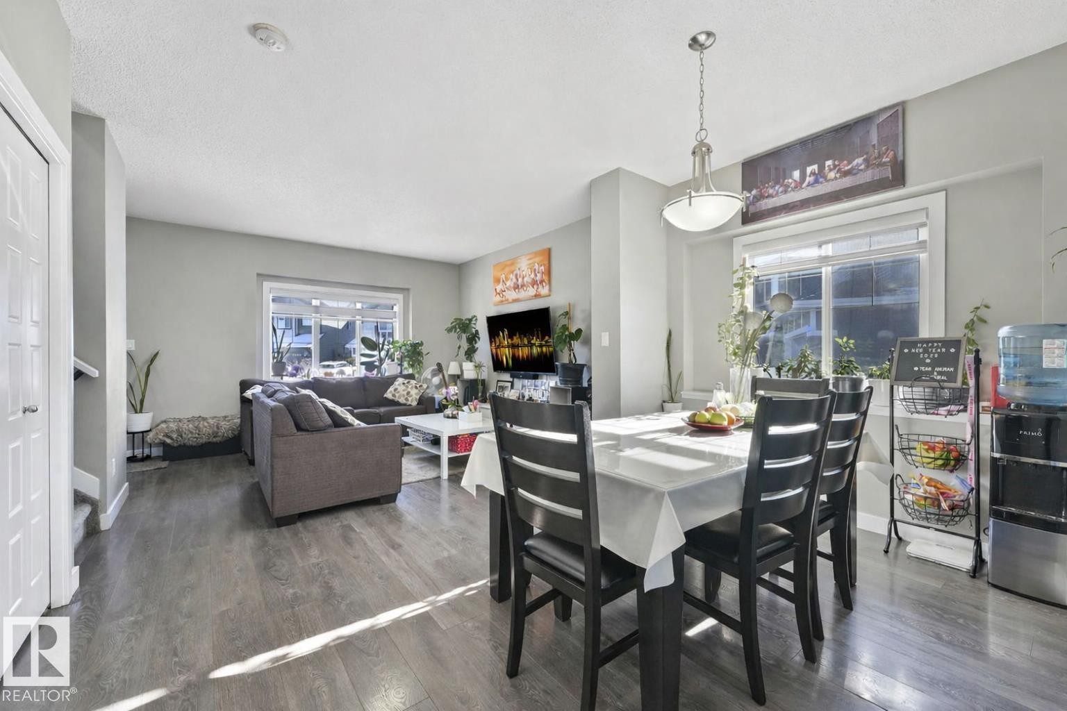 Dining room featuring dark wood-style floors and a textured ceiling - 2428 Wonnacott Crest, Edmonton, AB - Indoor