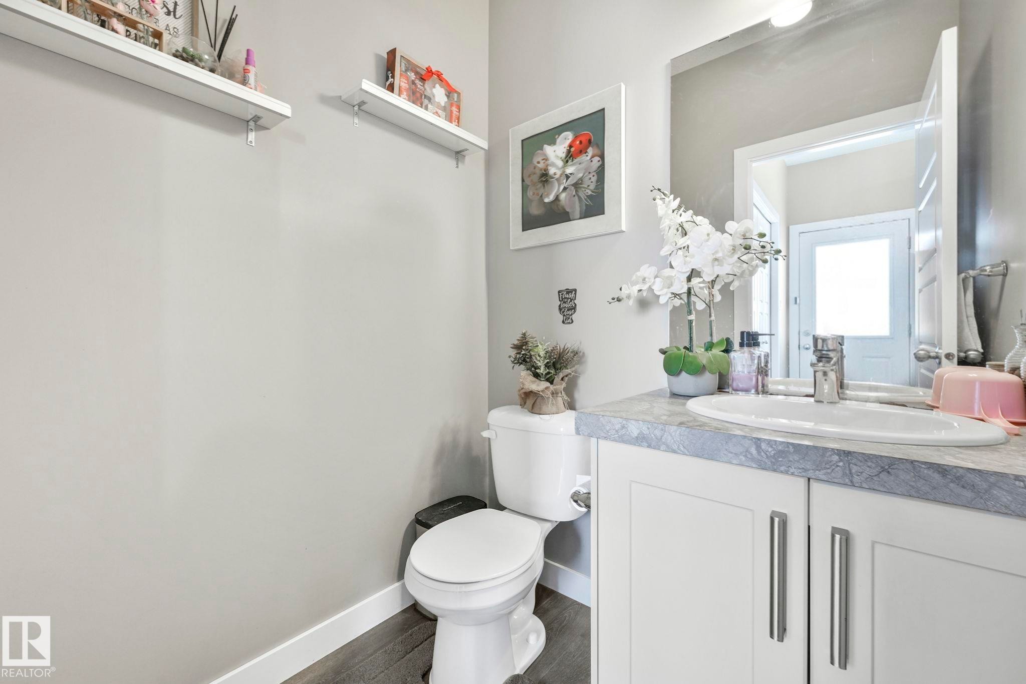 Bathroom with vanity and dark wood finished floors - 2428 Wonnacott Crest, Edmonton, AB - Indoor Photo Showing Bathroom