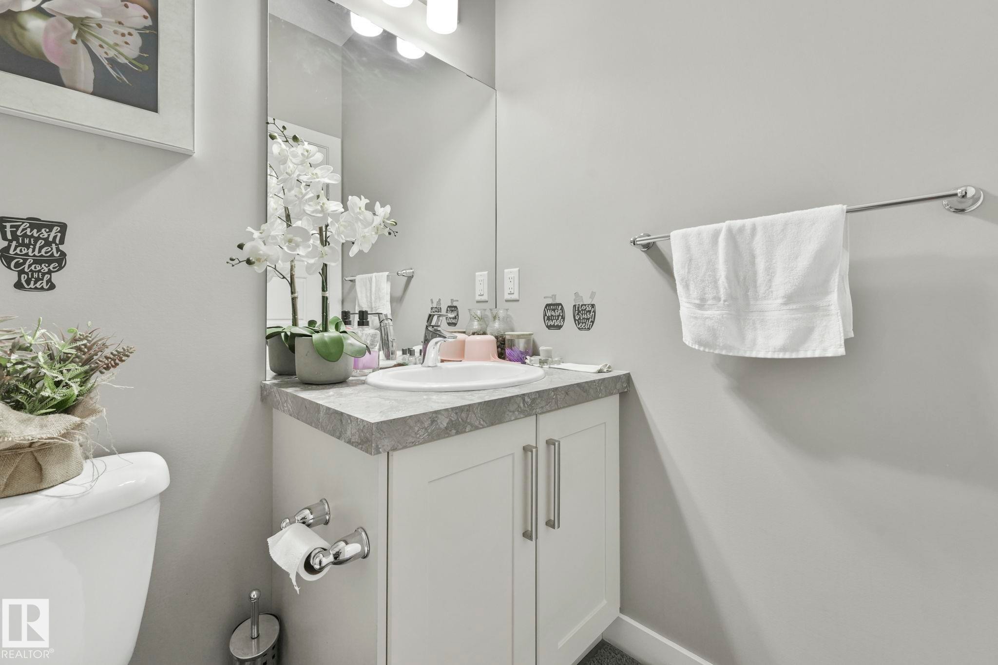 Half bath featuring vanity and toilet - 2428 Wonnacott Crest, Edmonton, AB - Indoor Photo Showing Bathroom