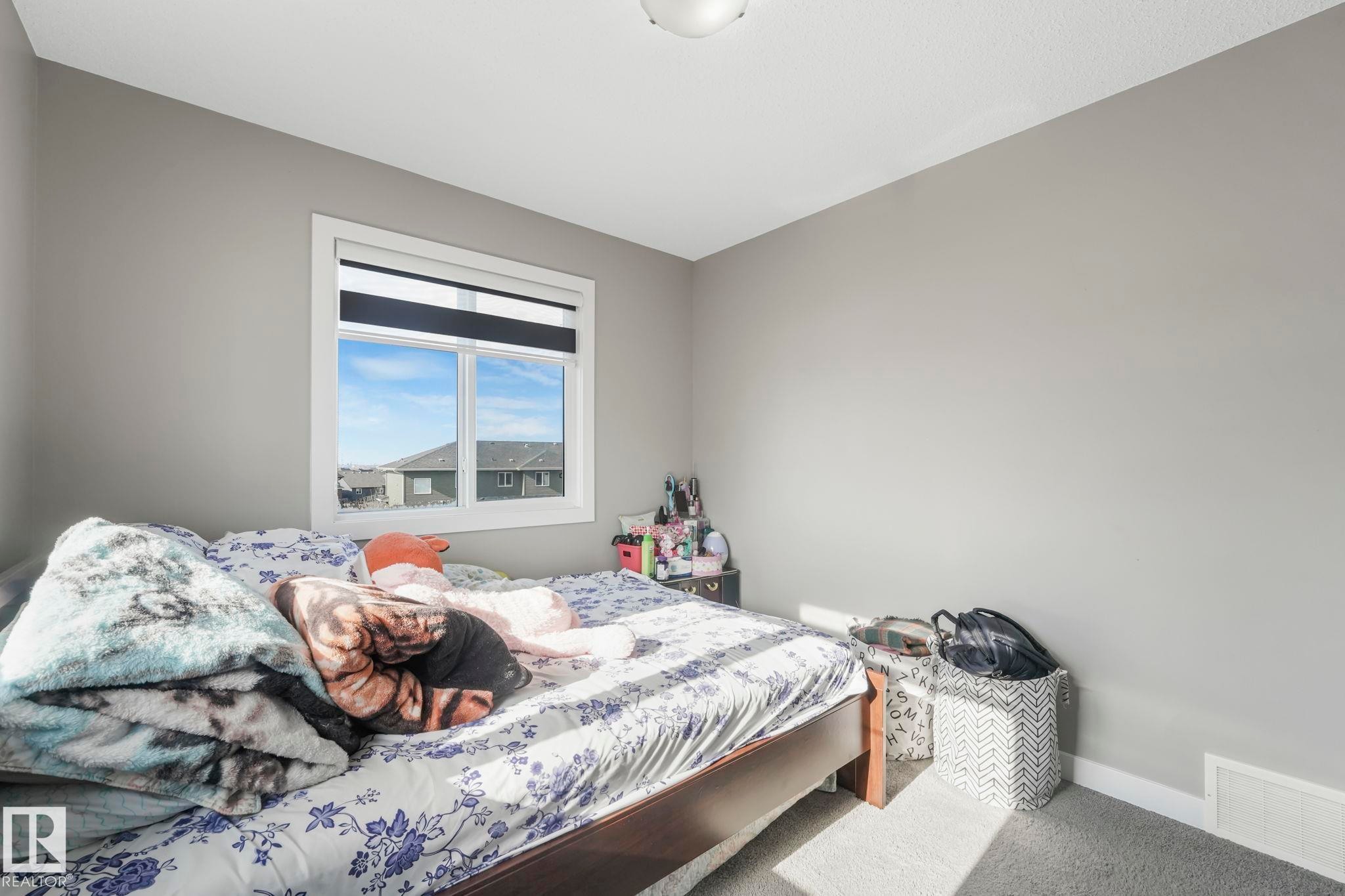 Bedroom featuring baseboards and carpet floors - 2428 Wonnacott Crest, Edmonton, AB - Indoor Photo Showing Bedroom
