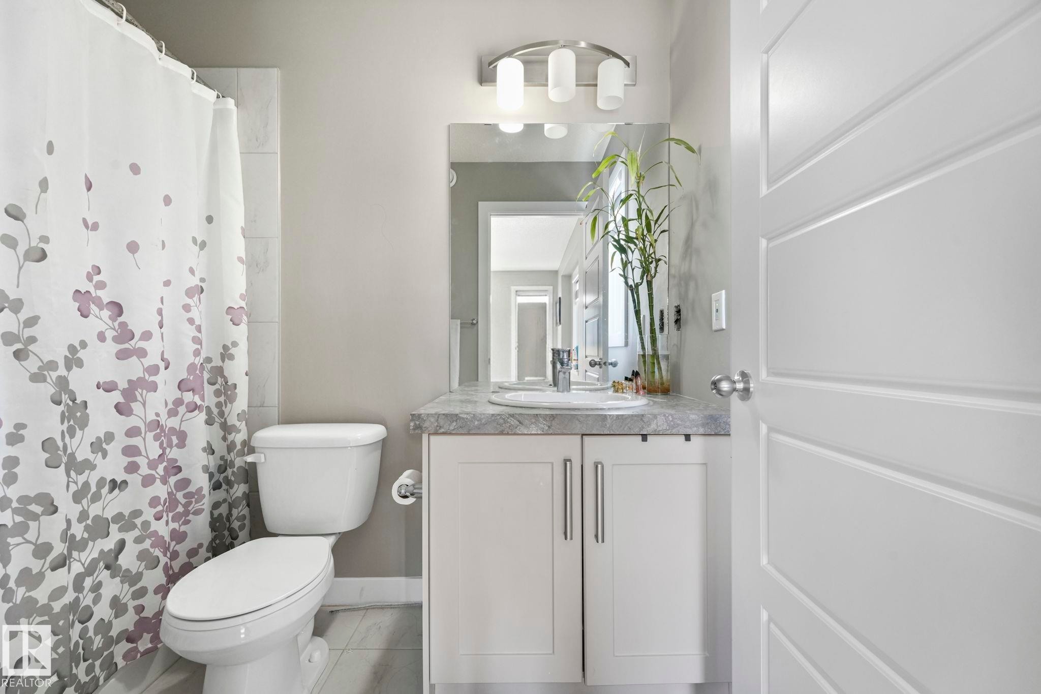 Full bath featuring vanity and a shower with shower curtain - 2428 Wonnacott Crest, Edmonton, AB - Indoor Photo Showing Bathroom