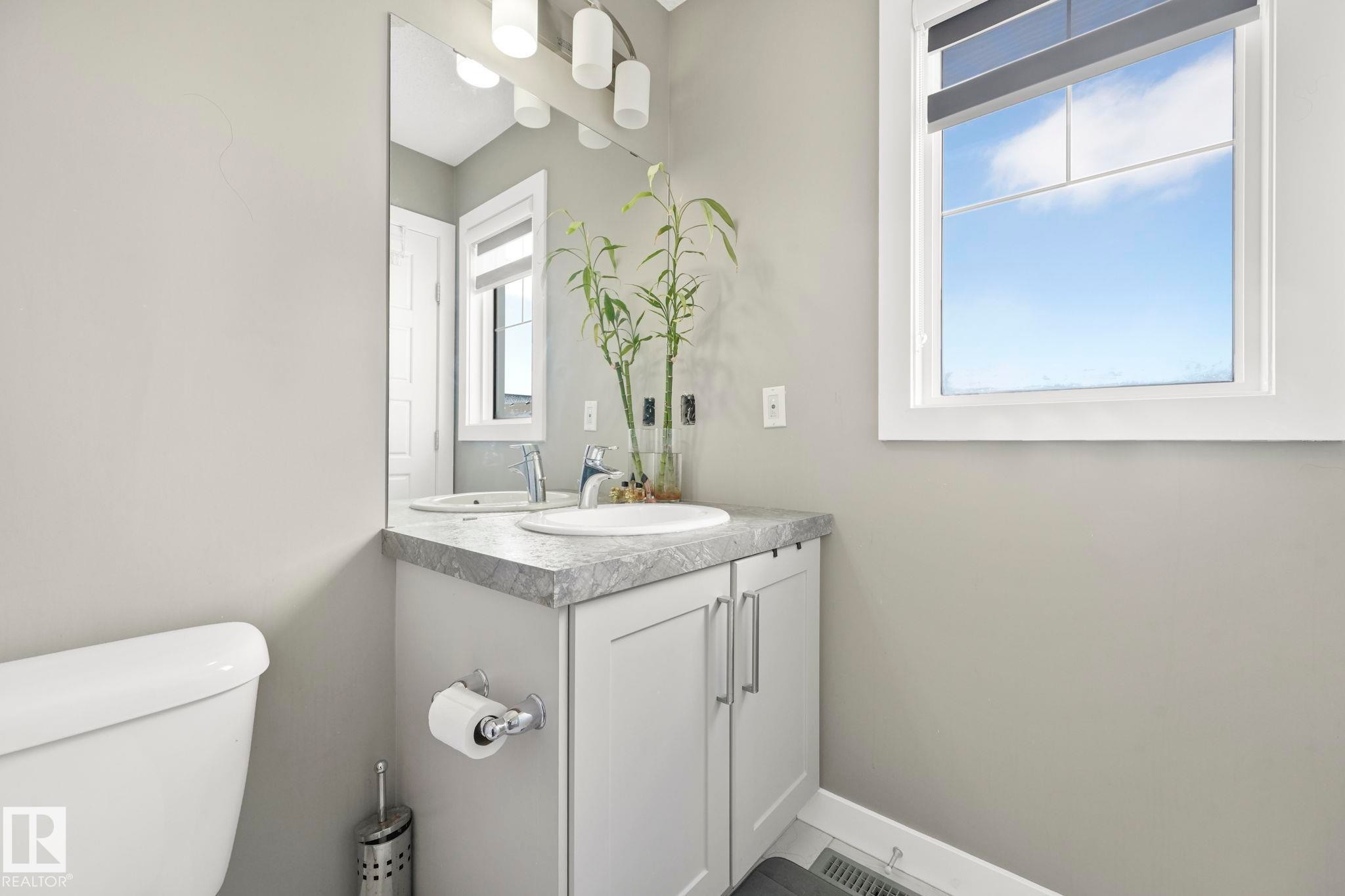 Half bathroom featuring vanity and toilet - 2428 Wonnacott Crest, Edmonton, AB - Indoor Photo Showing Bathroom