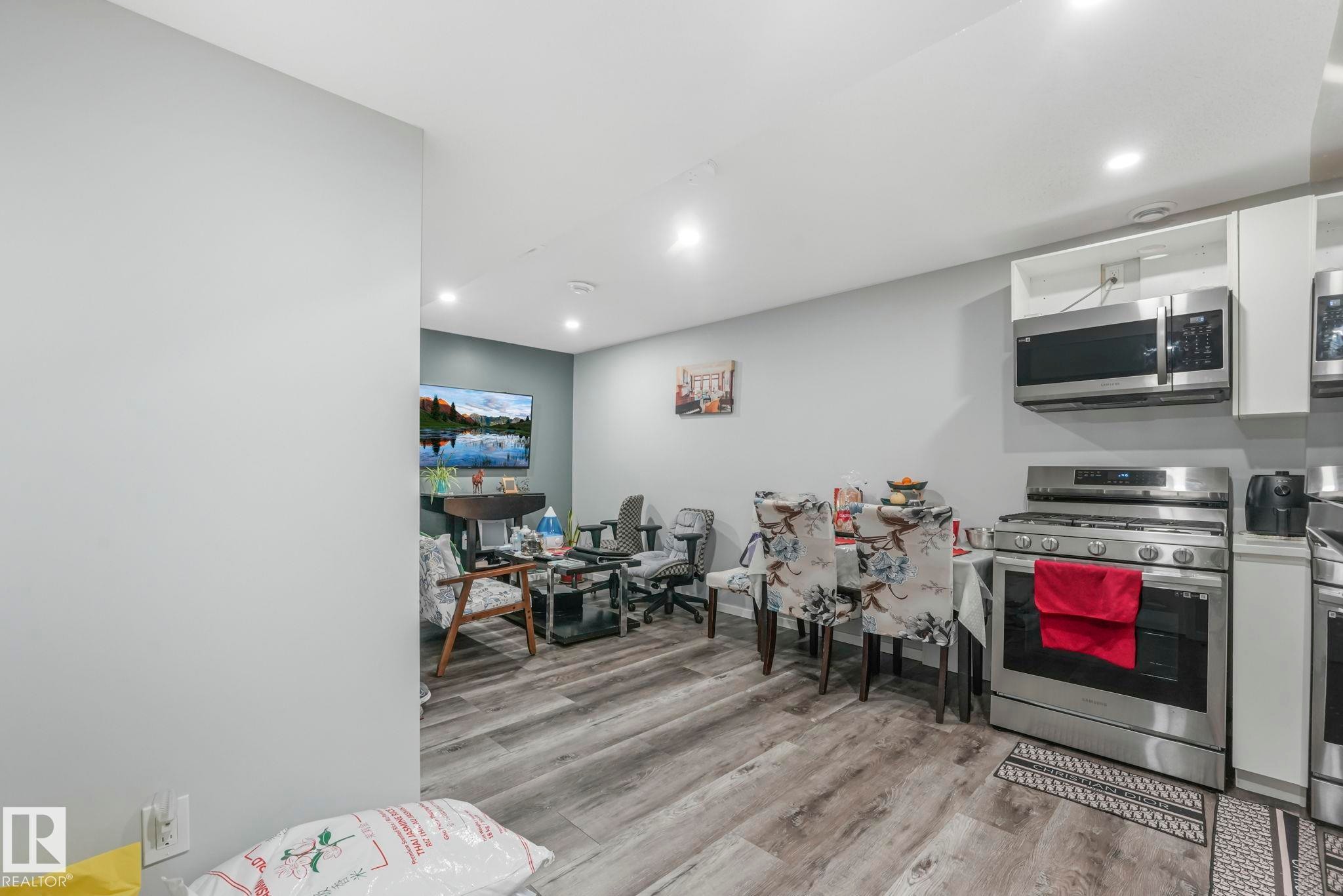 Kitchen featuring stainless steel appliances, light wood-type flooring, recessed lighting, white cabinets, and light countertops - 2428 Wonnacott Crest, Edmonton, AB - Indoor