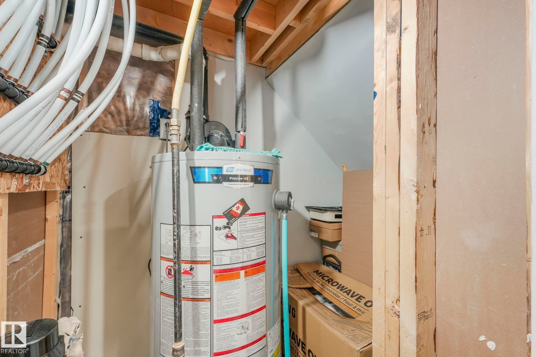 Utility room with water heater - 2428 Wonnacott Crest, Edmonton, AB - Indoor Photo Showing Basement