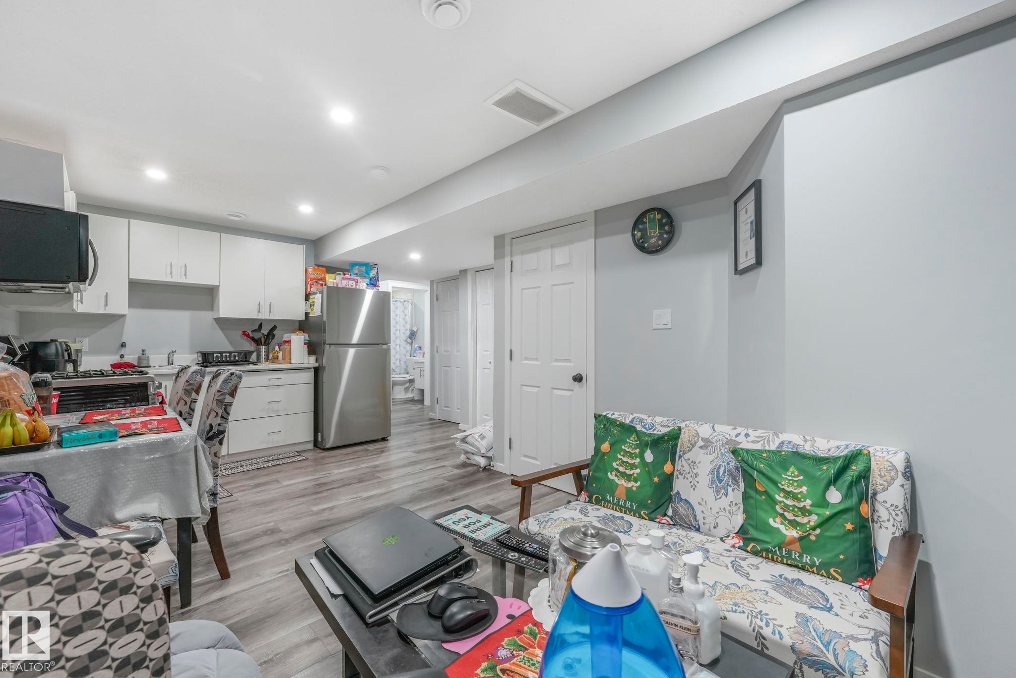 Living room featuring light wood finished floors and recessed lighting - 2428 Wonnacott Crest, Edmonton, AB - Indoor