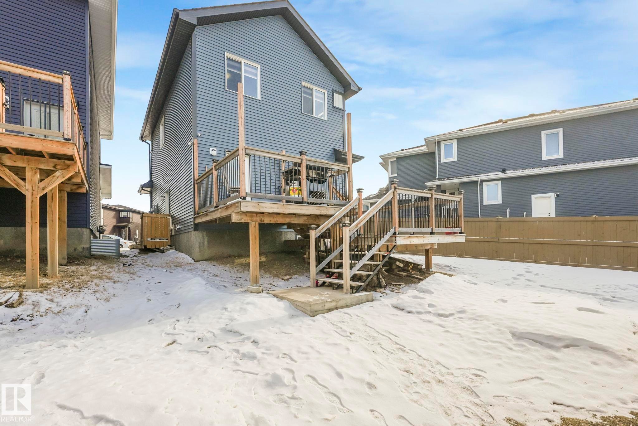 Snow covered house featuring a deck and stairway - 2428 Wonnacott Crest, Edmonton, AB - Outdoor With Deck Patio Veranda With Exterior