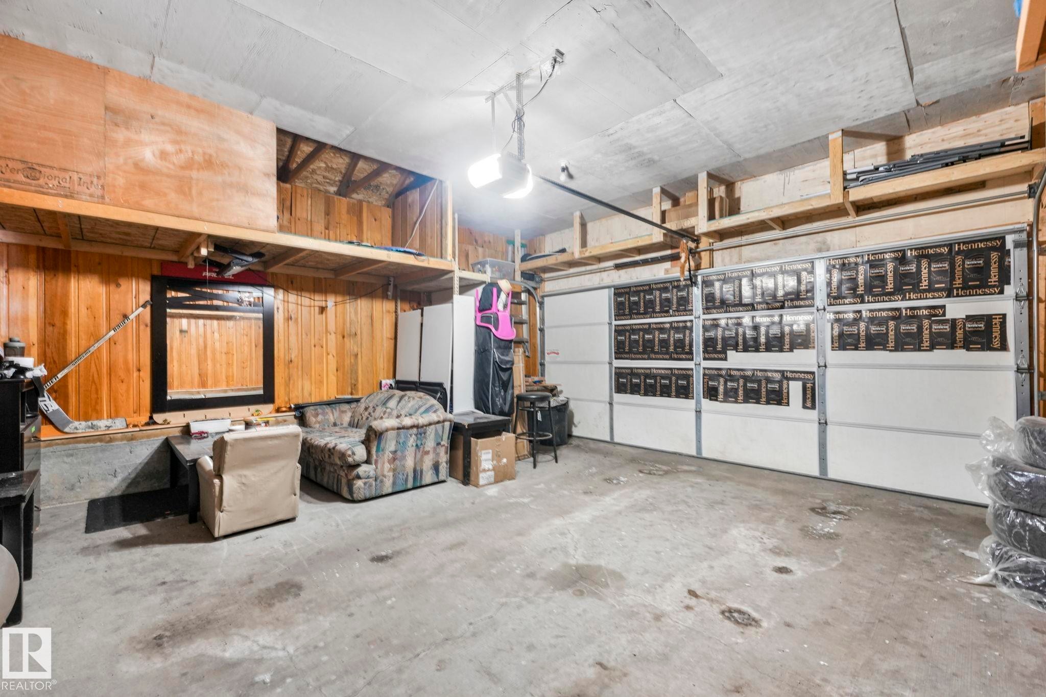 Garage featuring a garage door opener - 2428 Wonnacott Crest, Edmonton, AB - Indoor Photo Showing Garage