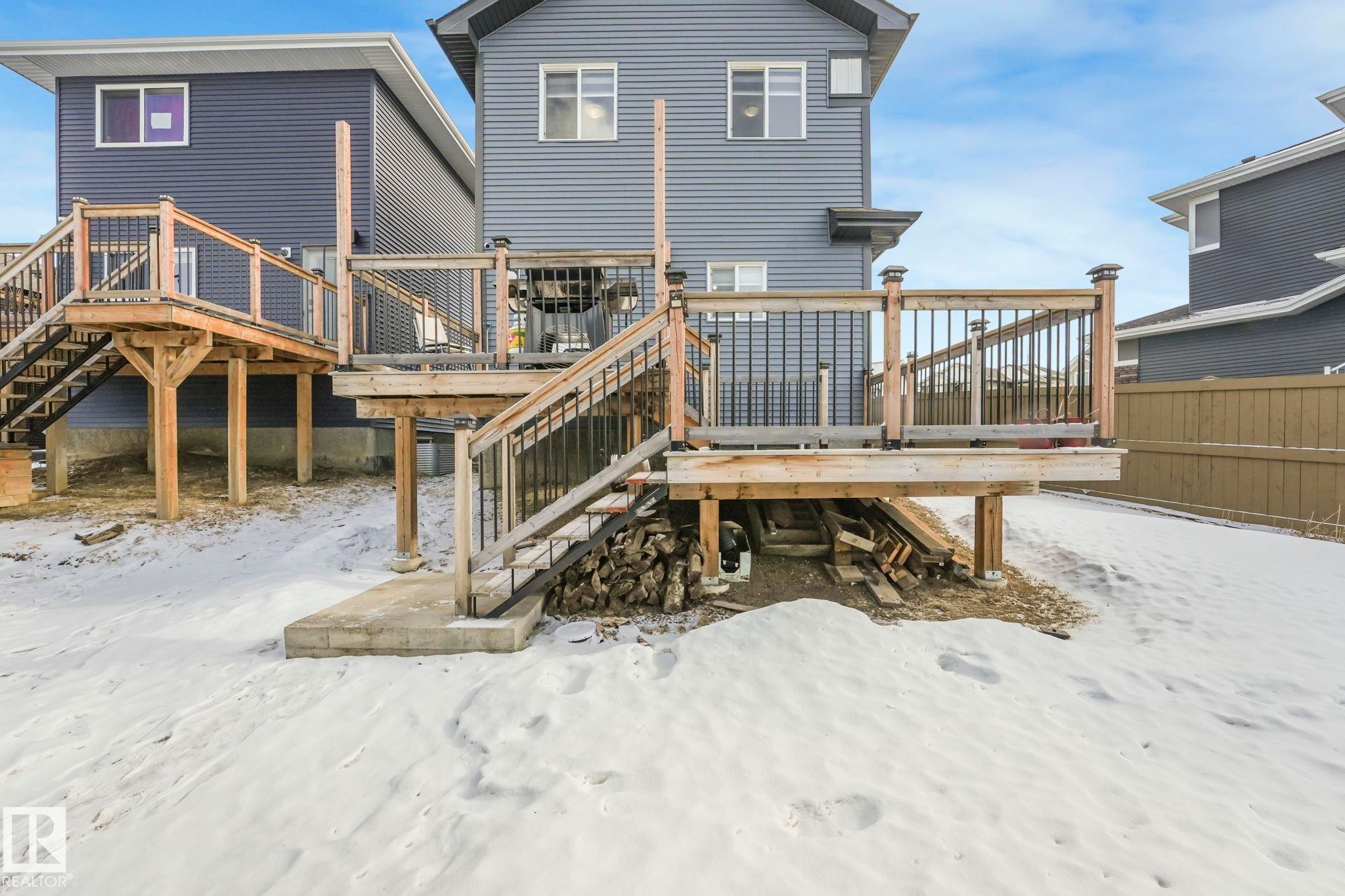 Snow covered house with stairway and a deck - 2428 Wonnacott Crest, Edmonton, AB - Outdoor With Deck Patio Veranda With Exterior