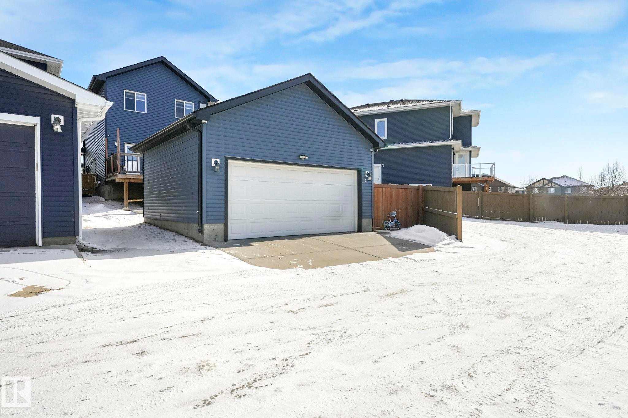Snow covered house featuring an outdoor structure - 2428 Wonnacott Crest, Edmonton, AB - Outdoor