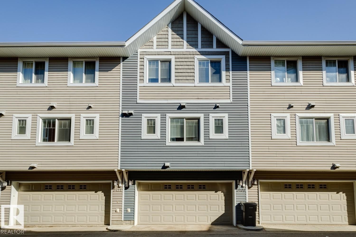 Rear view of property featuring a garage and driveway - 5409 3 Avenue, Edmonton, AB - Outdoor With Facade