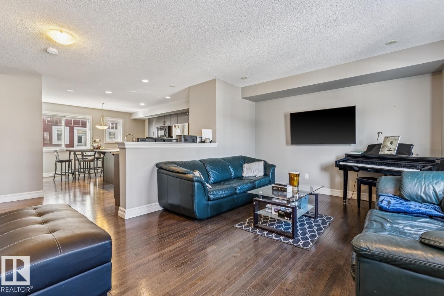 Living room featuring hardwood / wood-style flooring, a textured ceiling, and recessed lighting - 5409 3 Avenue, Edmonton, AB - Indoor Photo Showing Living Room
