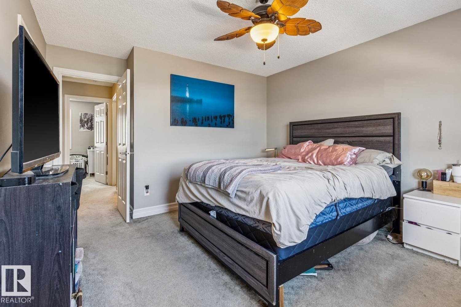 Bedroom with carpet floors, a textured ceiling, and ceiling fan - 5409 3 Avenue, Edmonton, AB - Indoor Photo Showing Bedroom