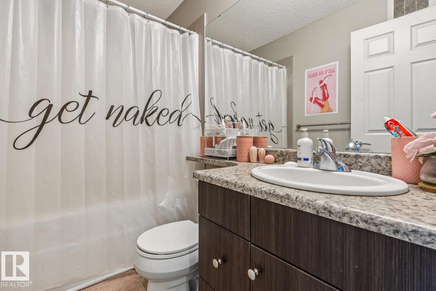 Full bathroom with vanity, shower / tub combo with curtain, and a textured ceiling - 5409 3 Avenue, Edmonton, AB - Indoor Photo Showing Bathroom