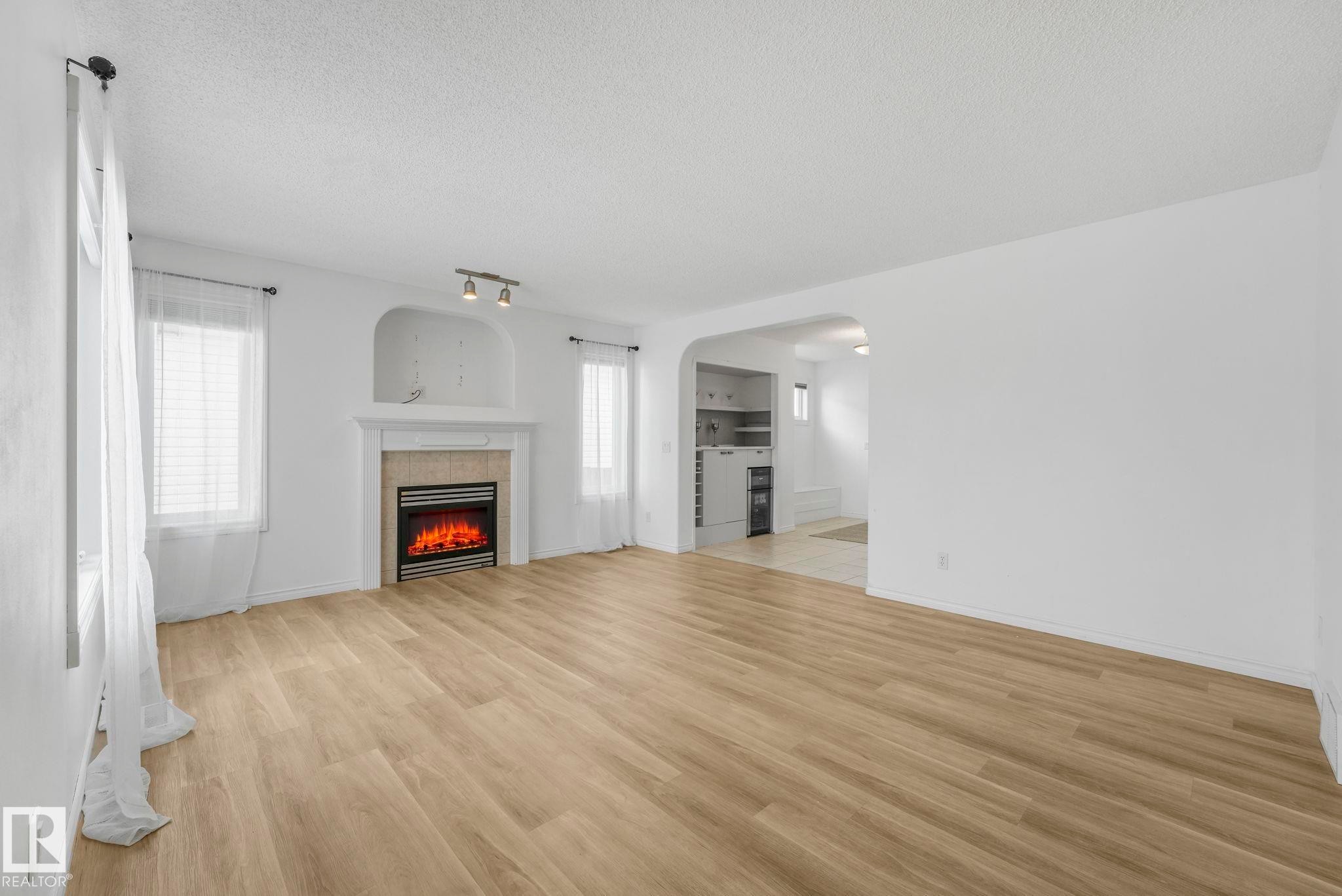12 Rue Bouchard, Beaumont, AB - Indoor Photo Showing Living Room With Fireplace