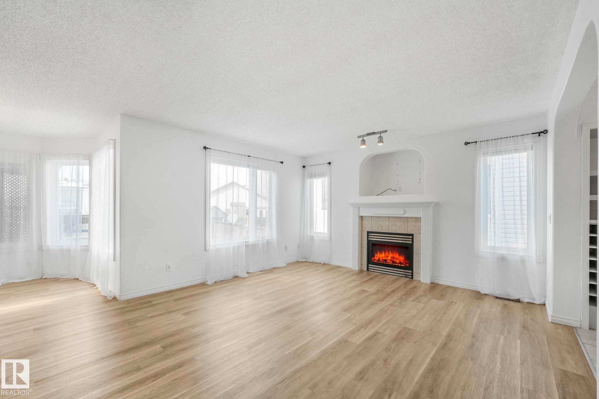 12 Rue Bouchard, Beaumont, AB - Indoor Photo Showing Living Room With Fireplace