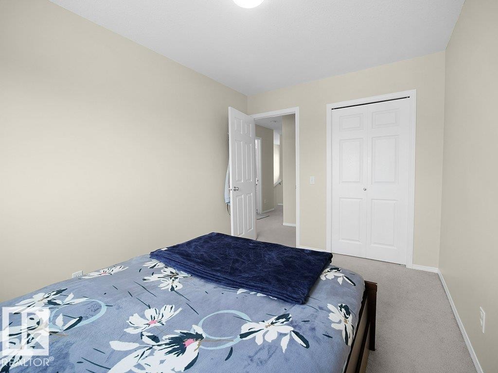 Carpeted bedroom featuring baseboards and a closet - 196 230 Edwards Drive, Edmonton, AB - Indoor Photo Showing Bedroom