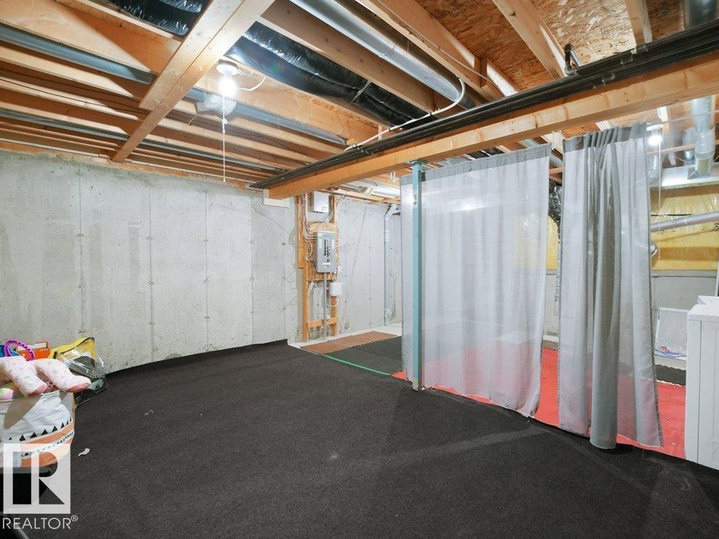 Unfinished below grade area featuring electric panel and washer / clothes dryer - 196 230 Edwards Drive, Edmonton, AB - Indoor Photo Showing Basement