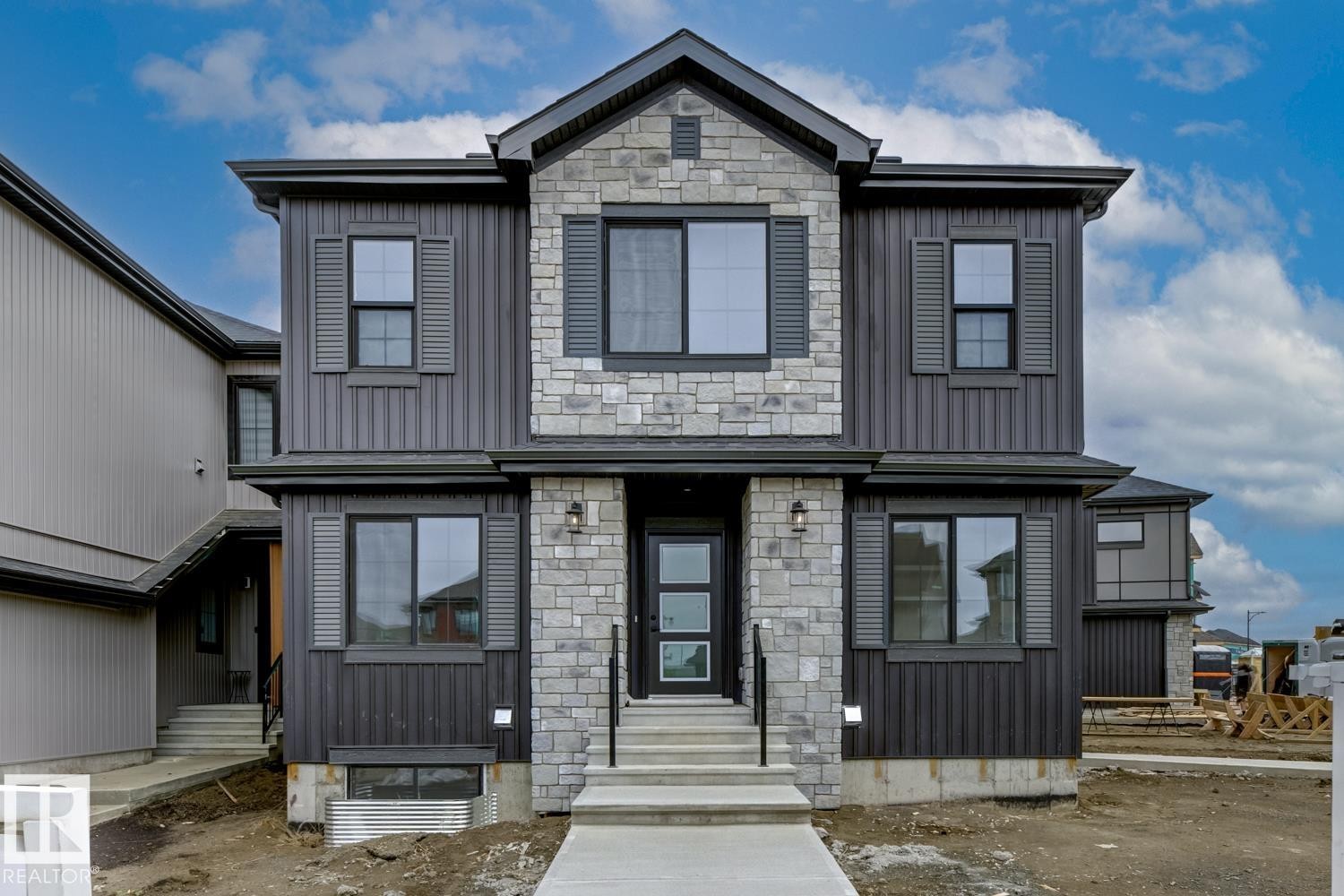 Contemporary two-story exterior featuring stone and vertical siding accents - 30 Chartres Close Nw, St. Albert, AB