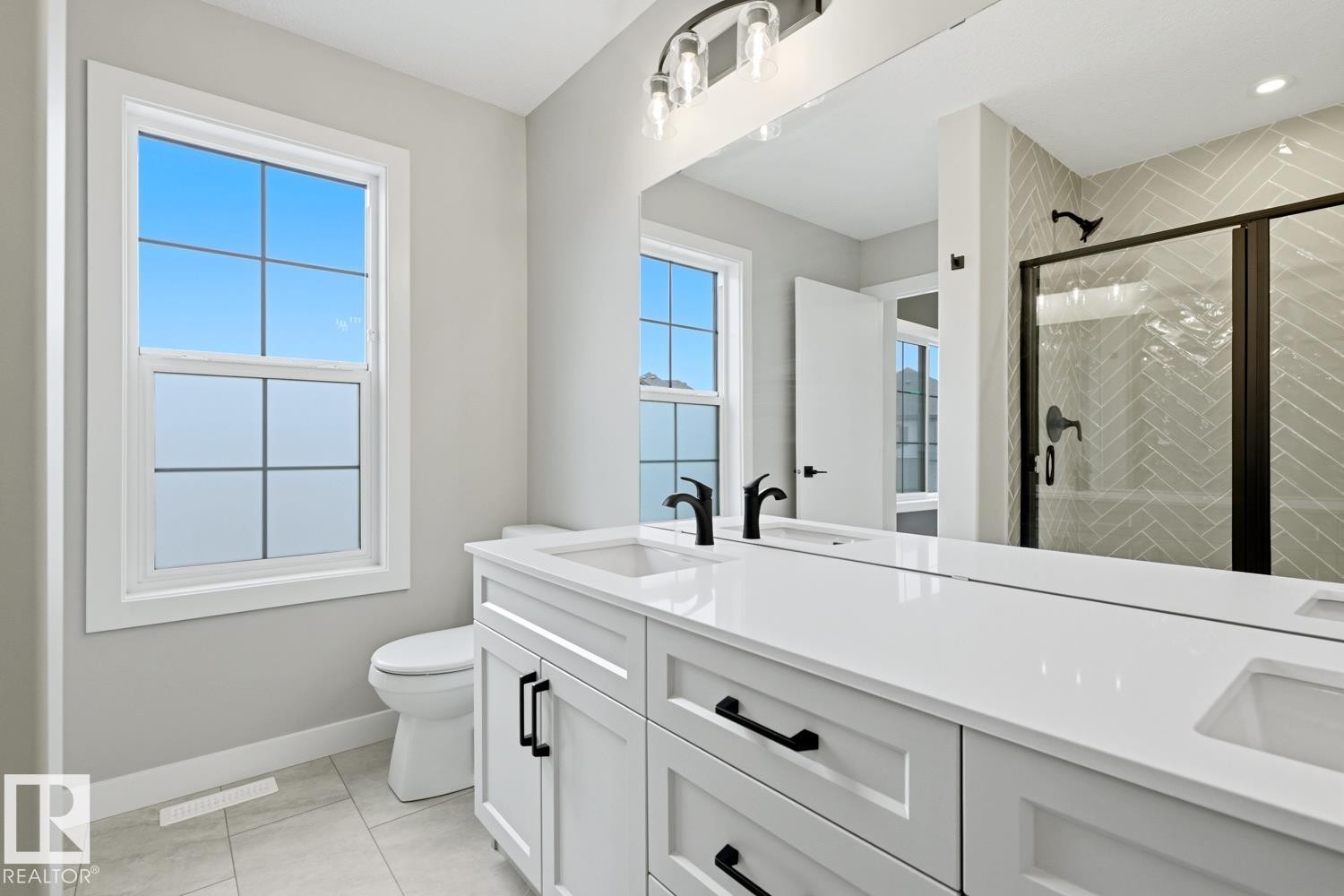 Double vanity with white cabinetry, matte black hardware, and integrated sinks - 30 Chartres Close Nw, St. Albert, AB