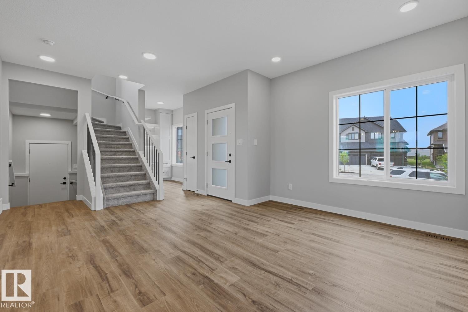 Light wood-finish flooring throughout, complemented by recessed ceiling lighting - 30 Chartres Close Nw, St. Albert, AB