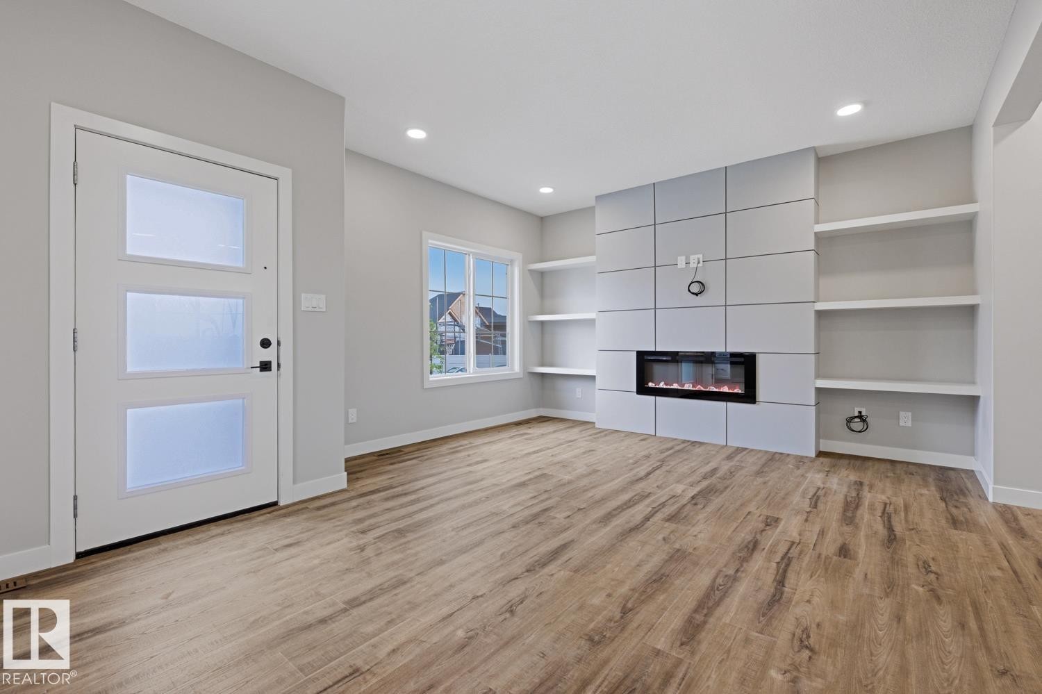 Living area featuring wood-finish flooring and recessed lighting - 30 Chartres Close Nw, St. Albert, AB