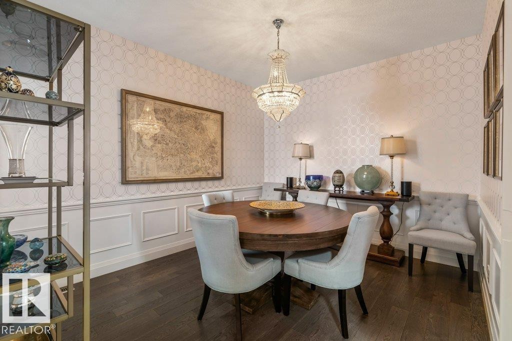 Formal Dining Room featuring Imported French Empire Chandelier, Wainscotting, and South Facing Window (Could be transitioned into a bedroom by reinstalling original doors) - 4476 Suzanna Crescent, Edmonton, AB - Indoor Photo Showing Dining Room