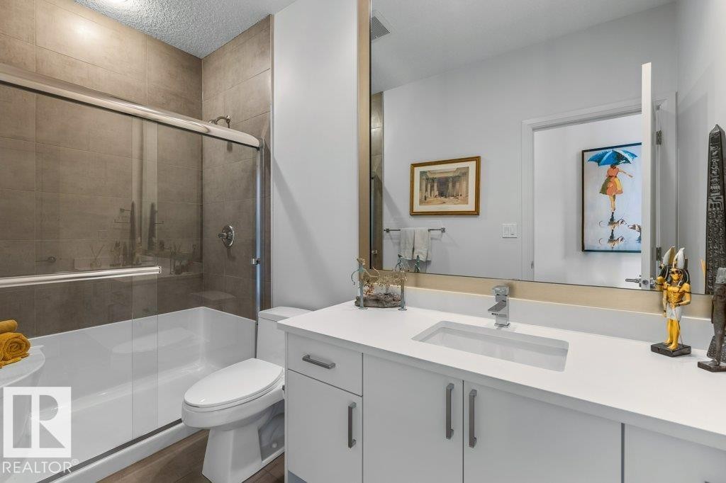 Main Floor 4 Piece Bathroom featuring Quartz Counters, White Cabinets, and Tiled Shower - 4476 Suzanna Crescent, Edmonton, AB - Indoor Photo Showing Bathroom