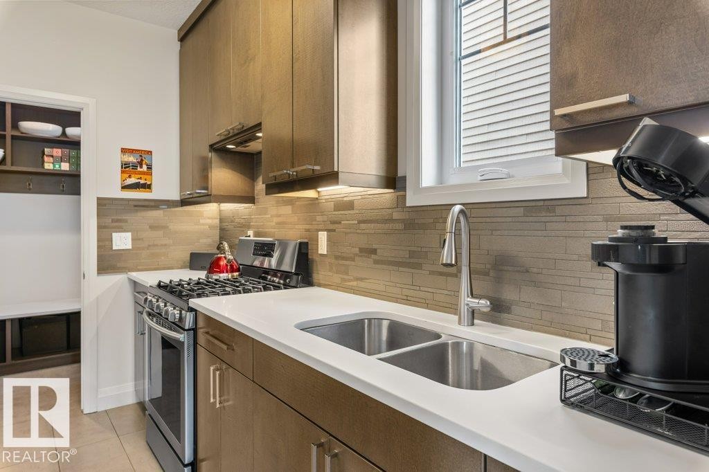 Secondary Main Floor Kitchen featuring Gas Stove, ample cabinet and counter space, and additional sink - 4476 Suzanna Crescent, Edmonton, AB - Indoor Photo Showing Kitchen With Double Sink