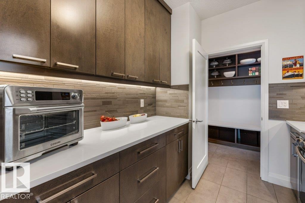 Secondary Main Floor Kitchen featuring Gas Stove, ample cabinet and counter space, and additional sink - 4476 Suzanna Crescent, Edmonton, AB - Indoor Photo Showing Kitchen