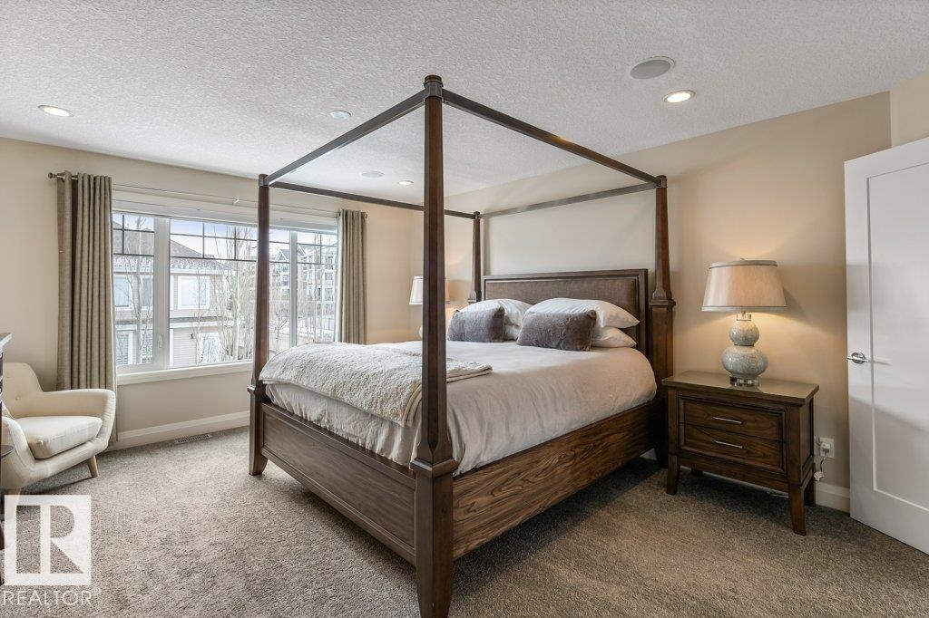 Large Primary Bedroom featuring East Facing Windows, Double Doors, and Ensuite - 4476 Suzanna Crescent, Edmonton, AB - Indoor Photo Showing Bedroom