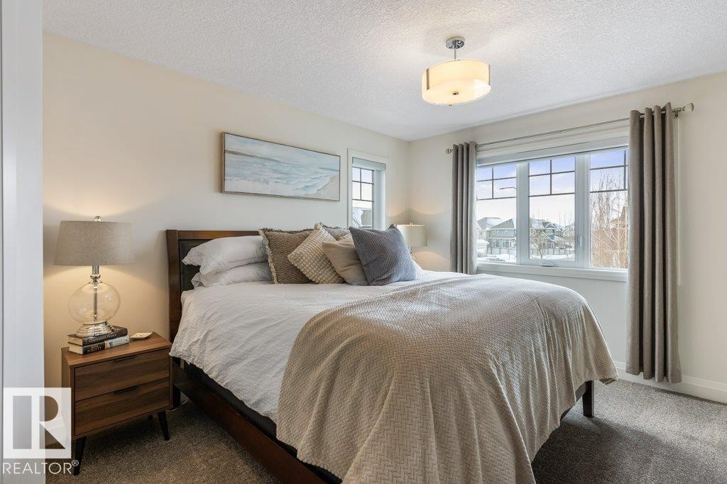 Bedroom featuring South West Facing Windows, and Walk In Closet - 4476 Suzanna Crescent, Edmonton, AB - Indoor Photo Showing Bedroom