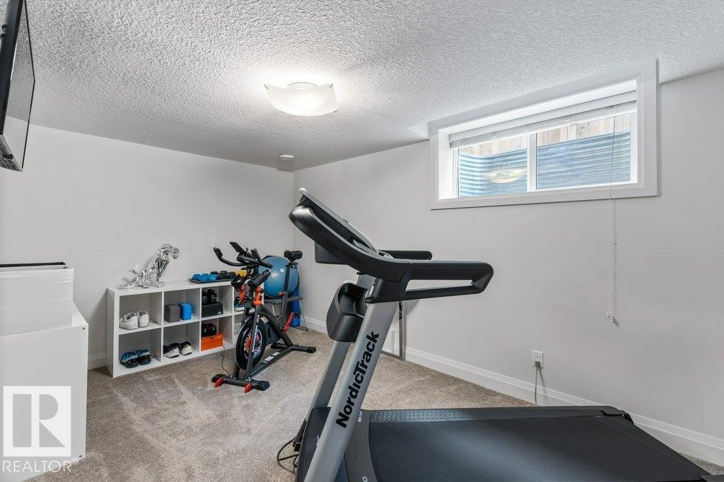 One of Two Basement Bedrooms - 4476 Suzanna Crescent, Edmonton, AB - Indoor Photo Showing Gym Room