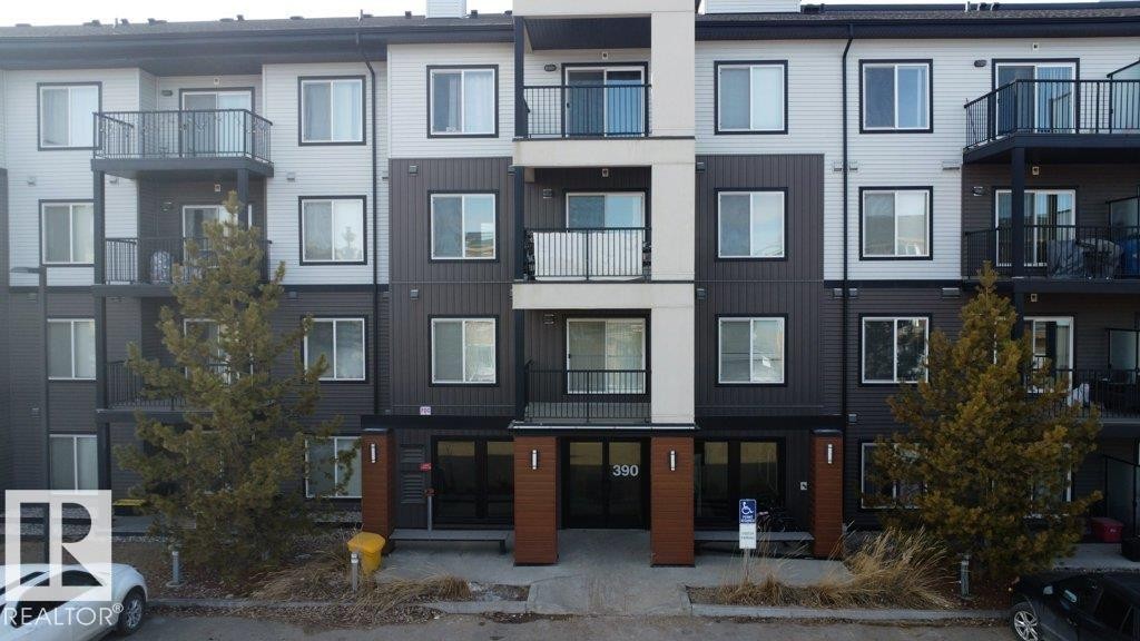 The property features a multi-story building with a modern facade, including balconies with dark railings - 429 390 Windermere Rd, Edmonton, AB - Outdoor With Balcony With Facade