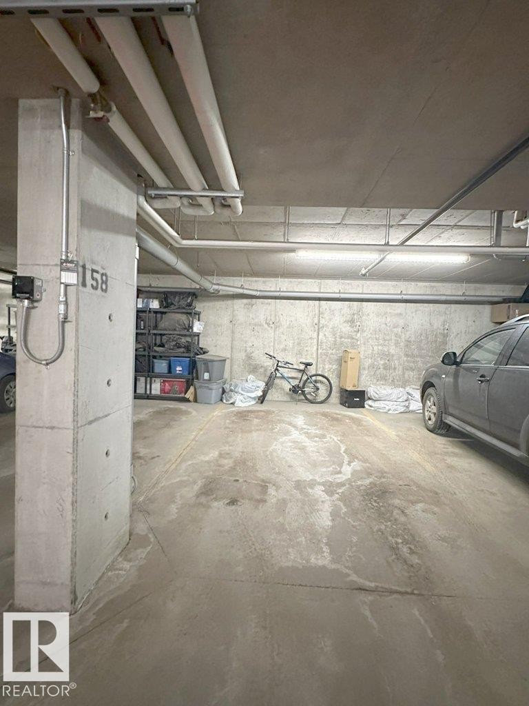 Dedicated parking space with concrete flooring and overhead lighting - 429 390 Windermere Rd, Edmonton, AB - Indoor Photo Showing Garage