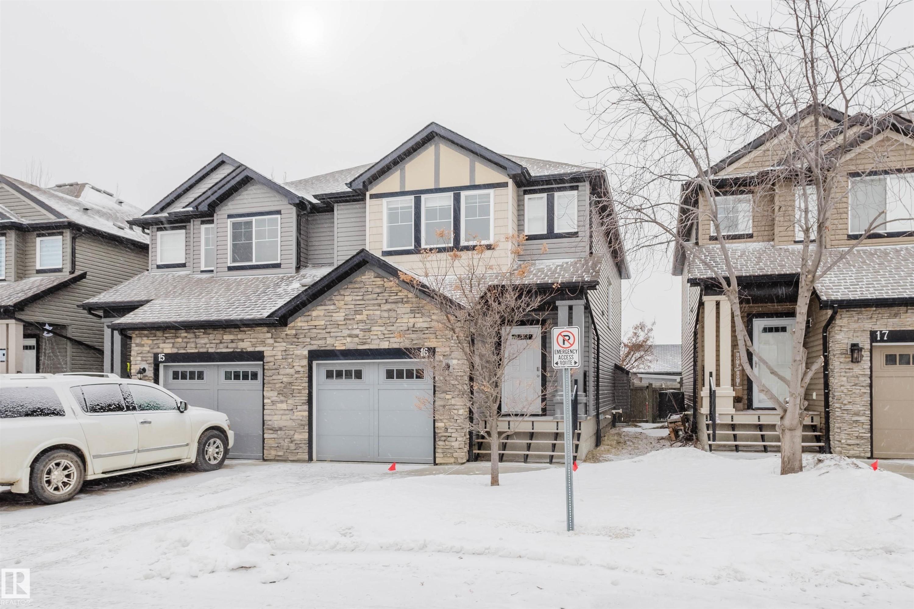 View of front of home featuring stone siding and a garage - Edmonton, AB - Outdoor With Facade