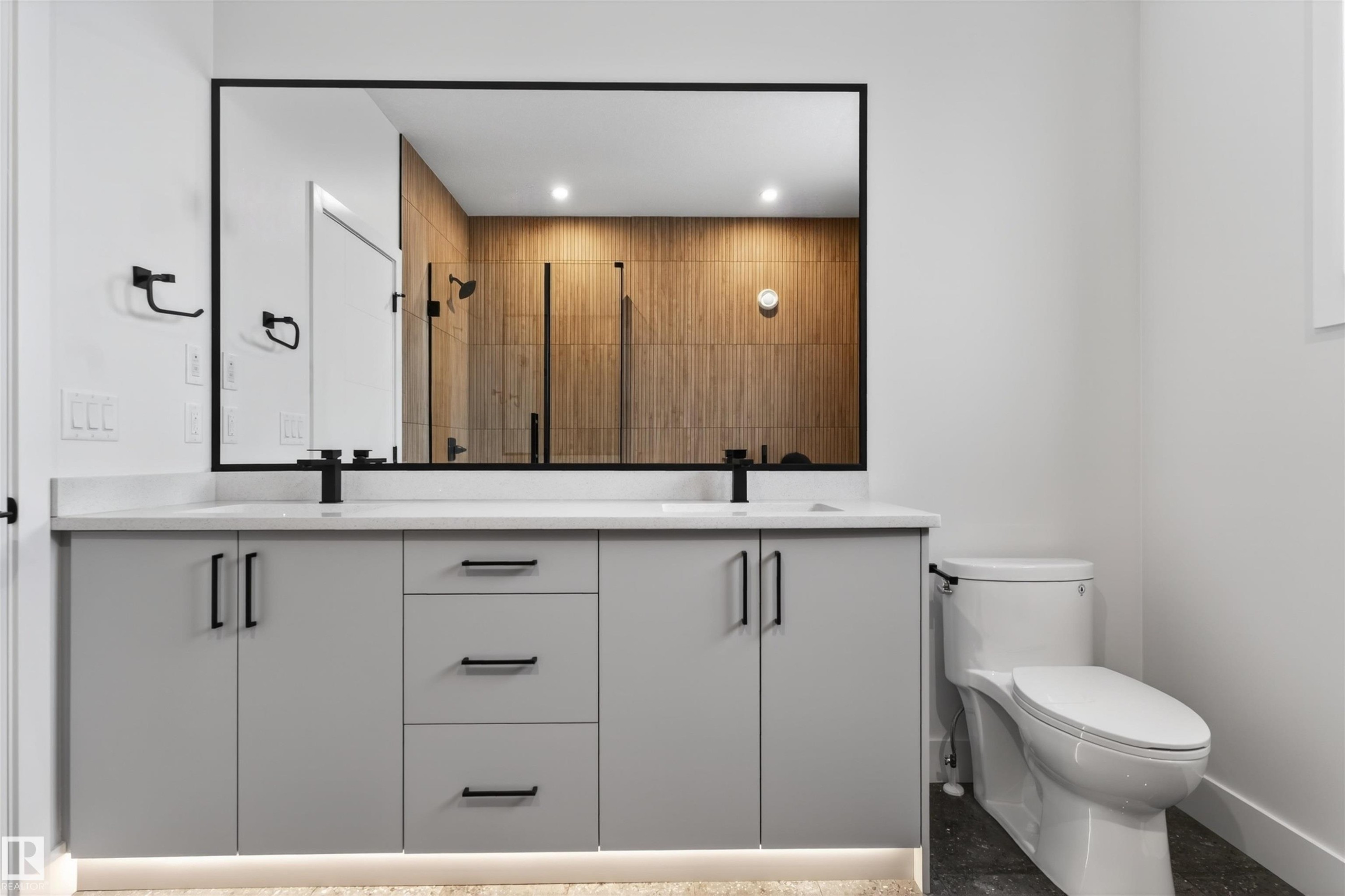 The bathroom features a double vanity with light gray cabinetry, white countertops, and matte black fixtures - 11 Redbud Way, St. Albert, AB - Indoor Photo Showing Bathroom