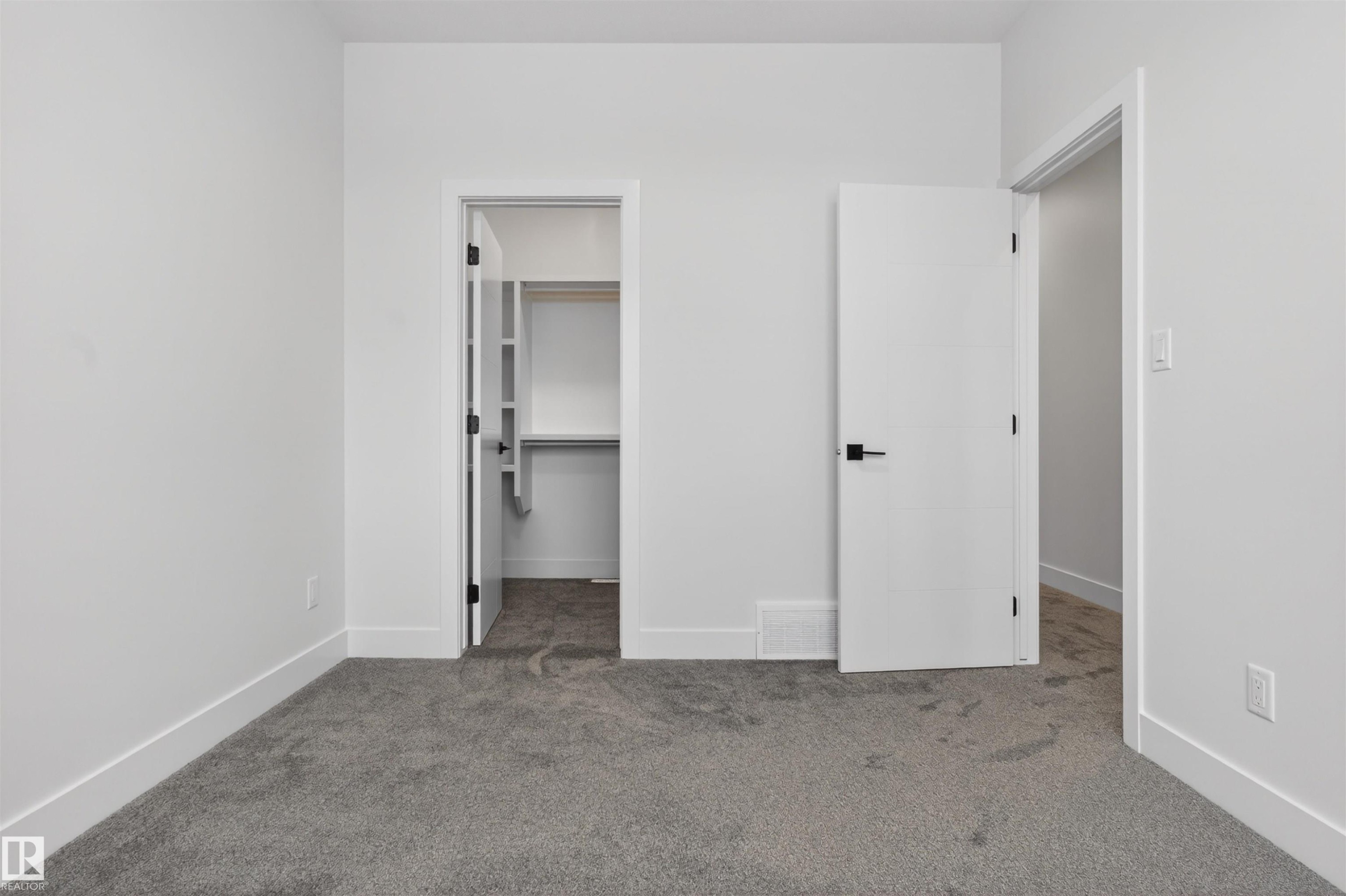 This room features light grey carpet flooring and white walls - 11 Redbud Way, St. Albert, AB - Indoor Photo Showing Other Room