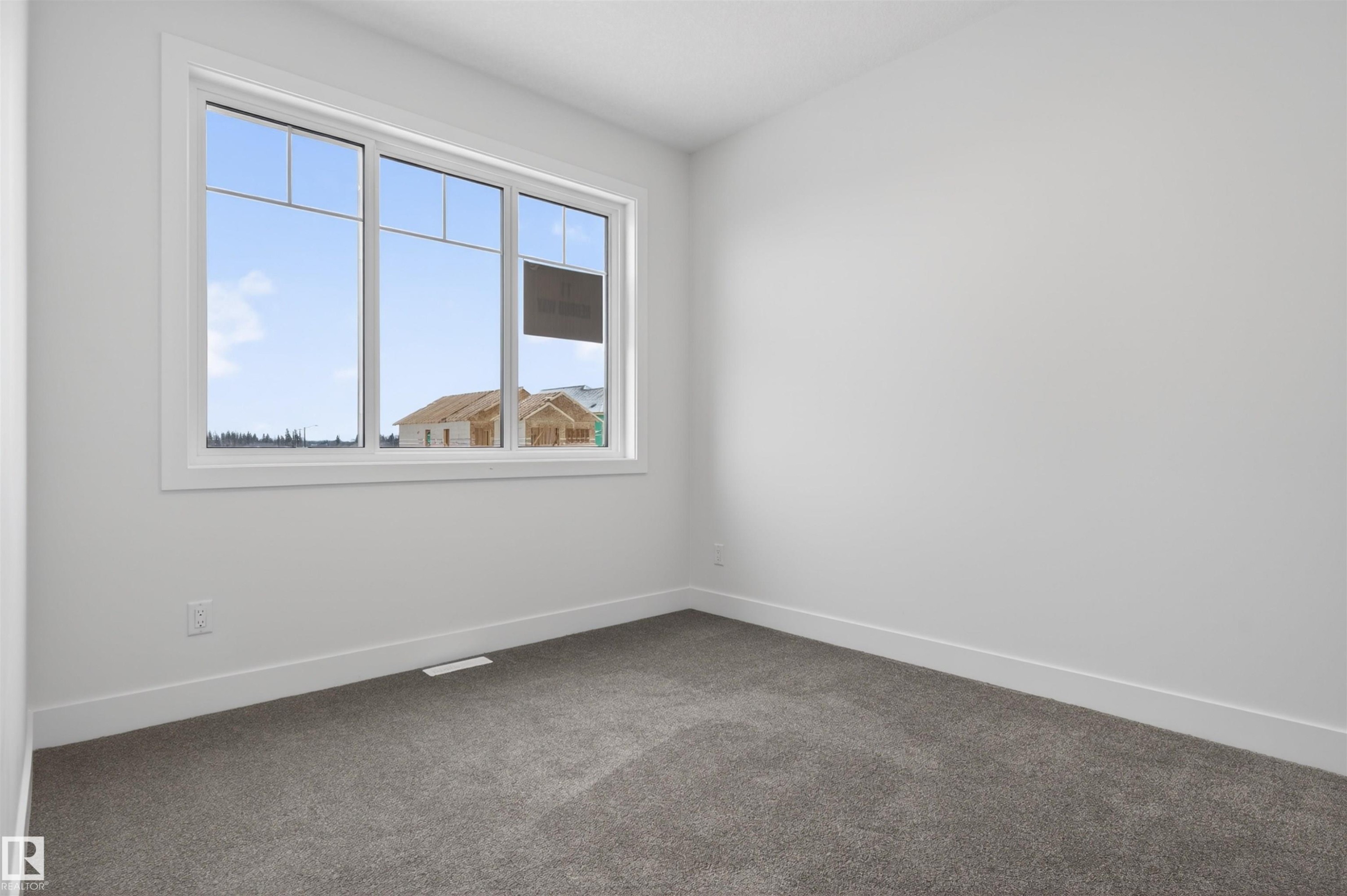 This room features a large window with white framing, providing natural light - 11 Redbud Way, St. Albert, AB - Indoor Photo Showing Other Room
