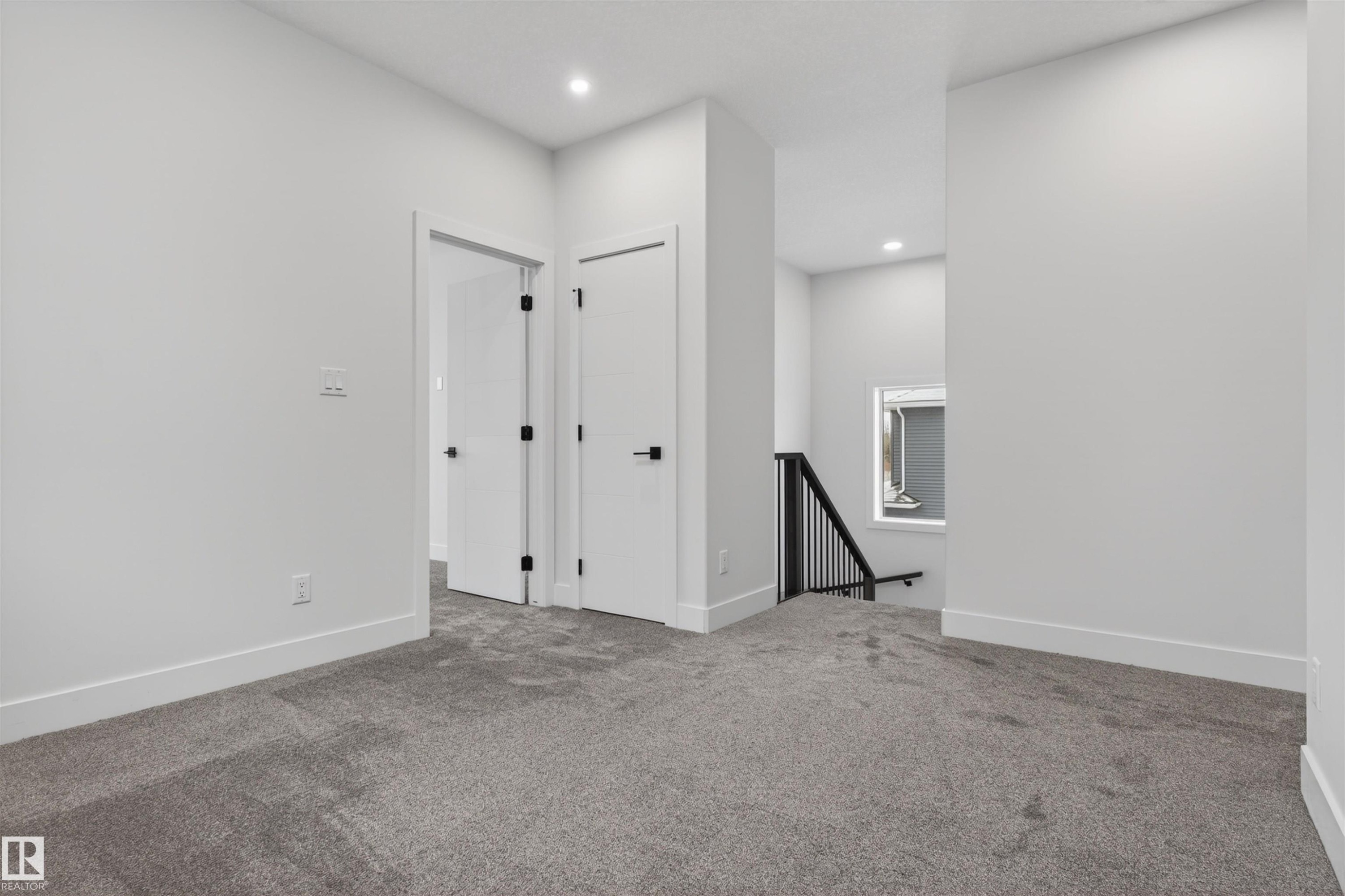 This interior space features light grey carpeting, white walls, and white trim - 11 Redbud Way, St. Albert, AB - Indoor Photo Showing Other Room
