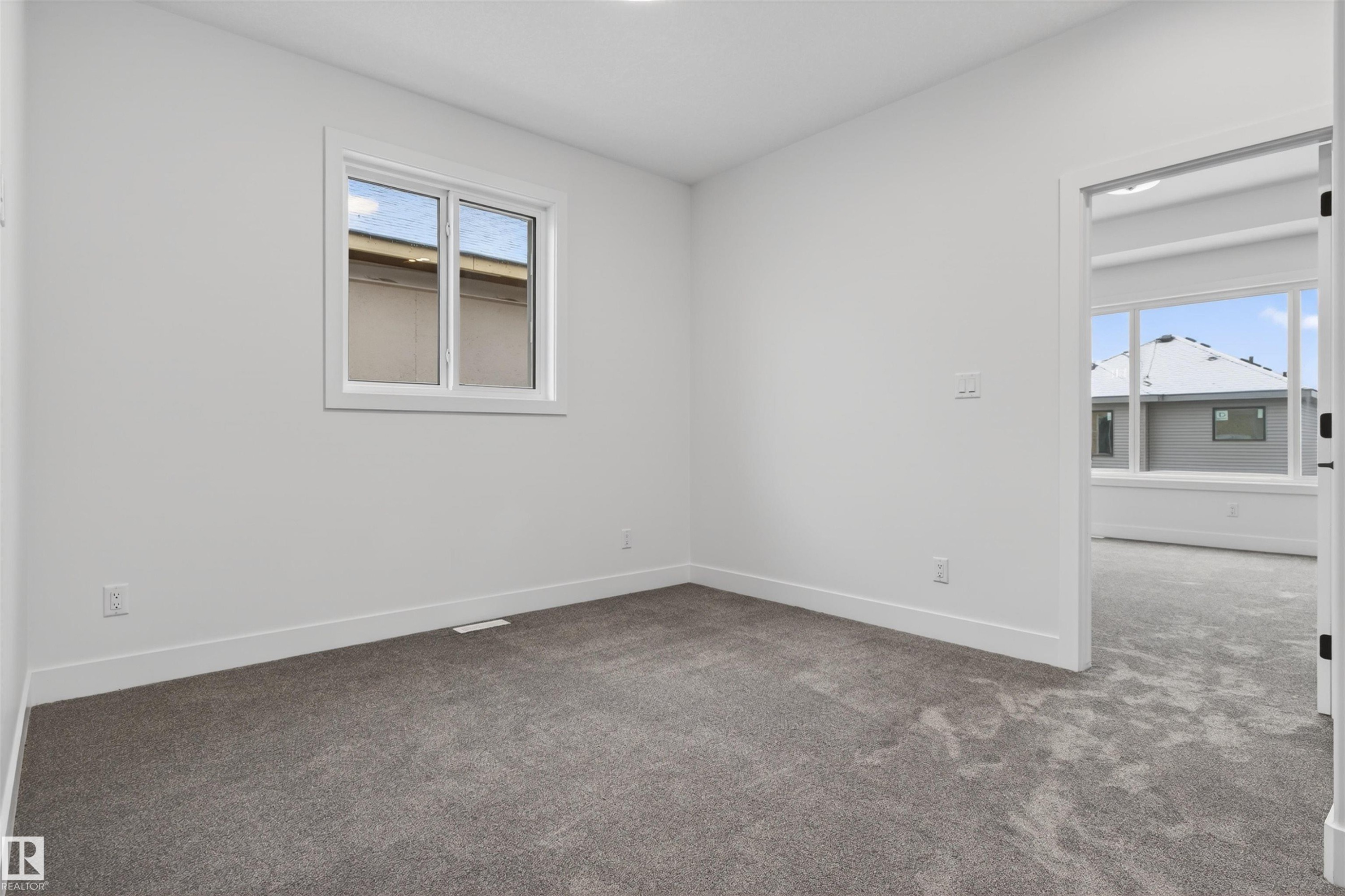 This room features neutral-toned carpet, white walls, and a window providing natural light - 11 Redbud Way, St. Albert, AB - Indoor Photo Showing Other Room
