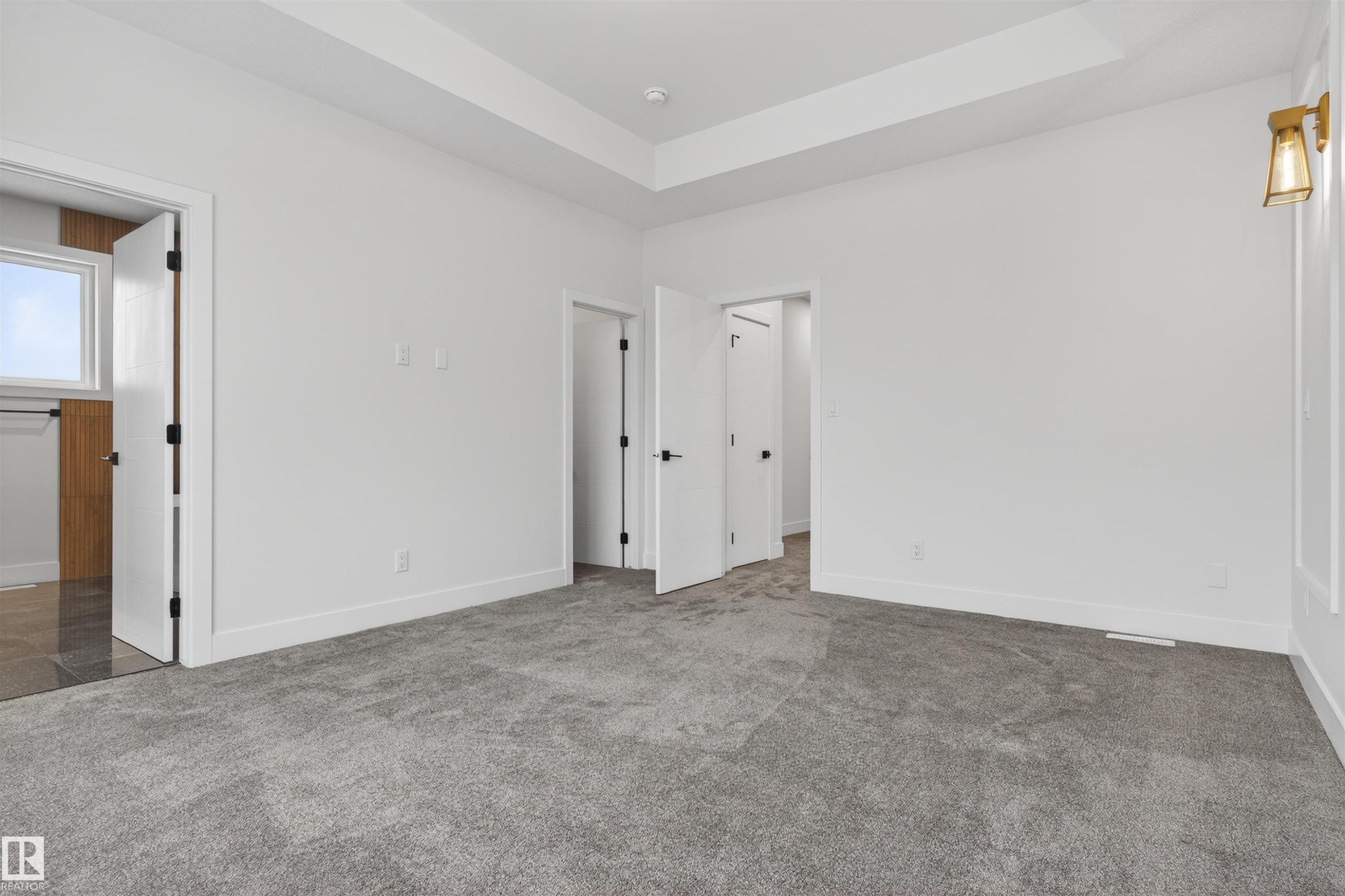 This room features a gray carpet, white walls, and a tray ceiling - 11 Redbud Way, St. Albert, AB - Indoor Photo Showing Other Room