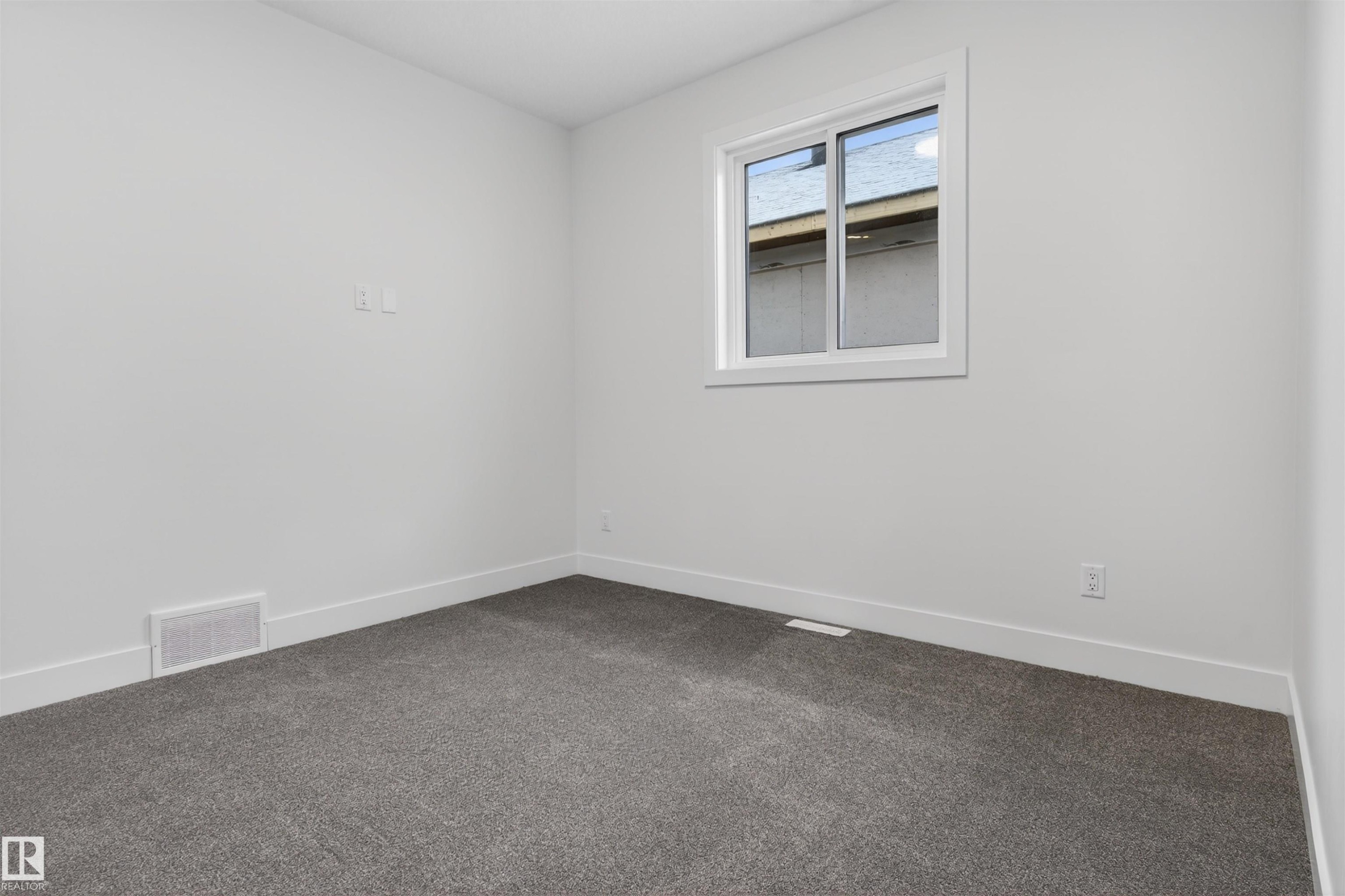 This room features light grey walls, white trim, and dark grey carpeting, creating a neutral palette - 11 Redbud Way, St. Albert, AB - Indoor Photo Showing Other Room