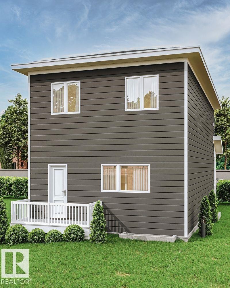 The property features a well-maintained lawn and a white deck with railings, providing an outdoor living space - 37 River Birch Way, St. Albert, AB - Outdoor With Exterior
