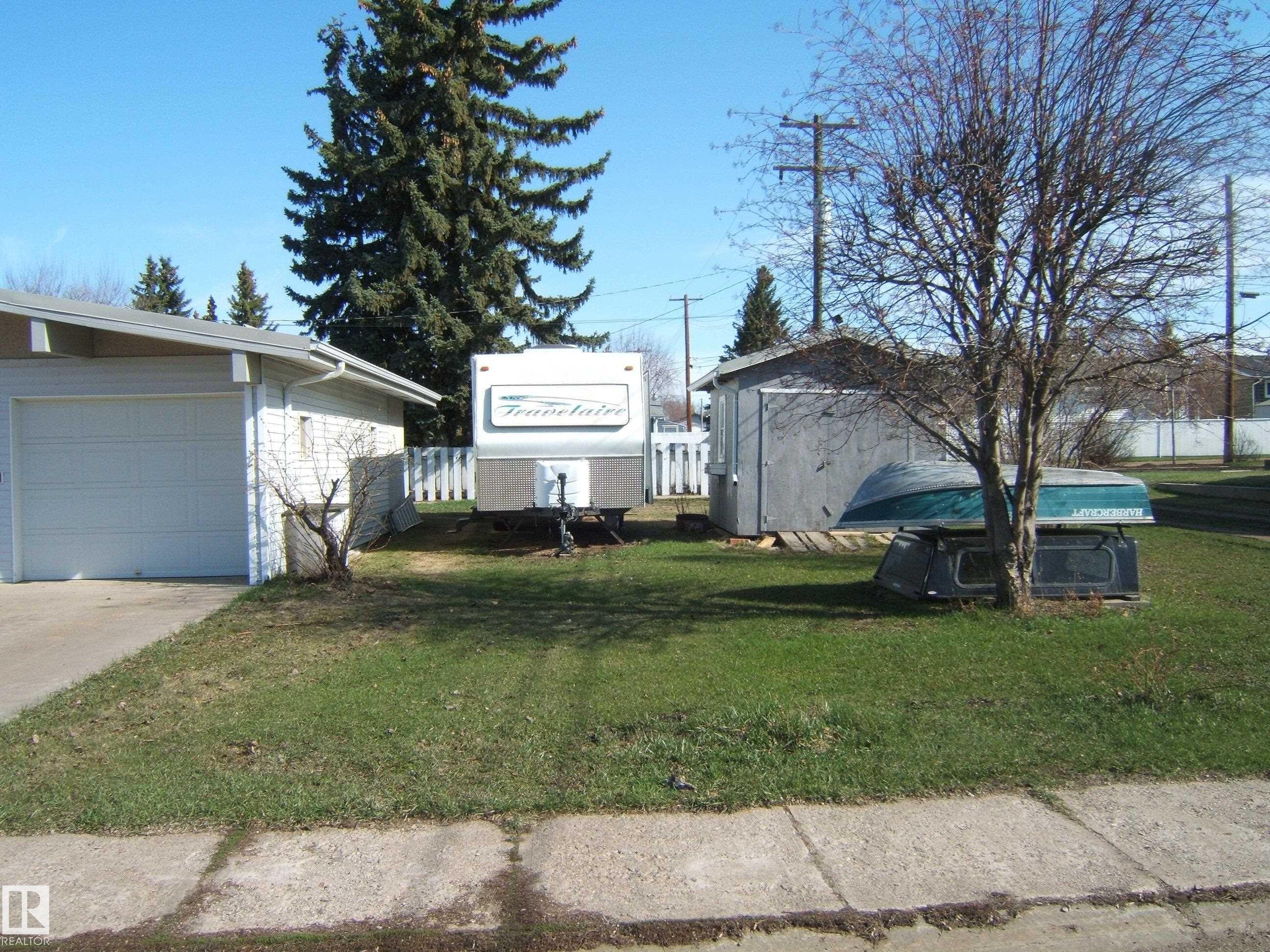 Attached garage with white panel door - 4702 52 Avenue, Two Hills, AB - Outdoor