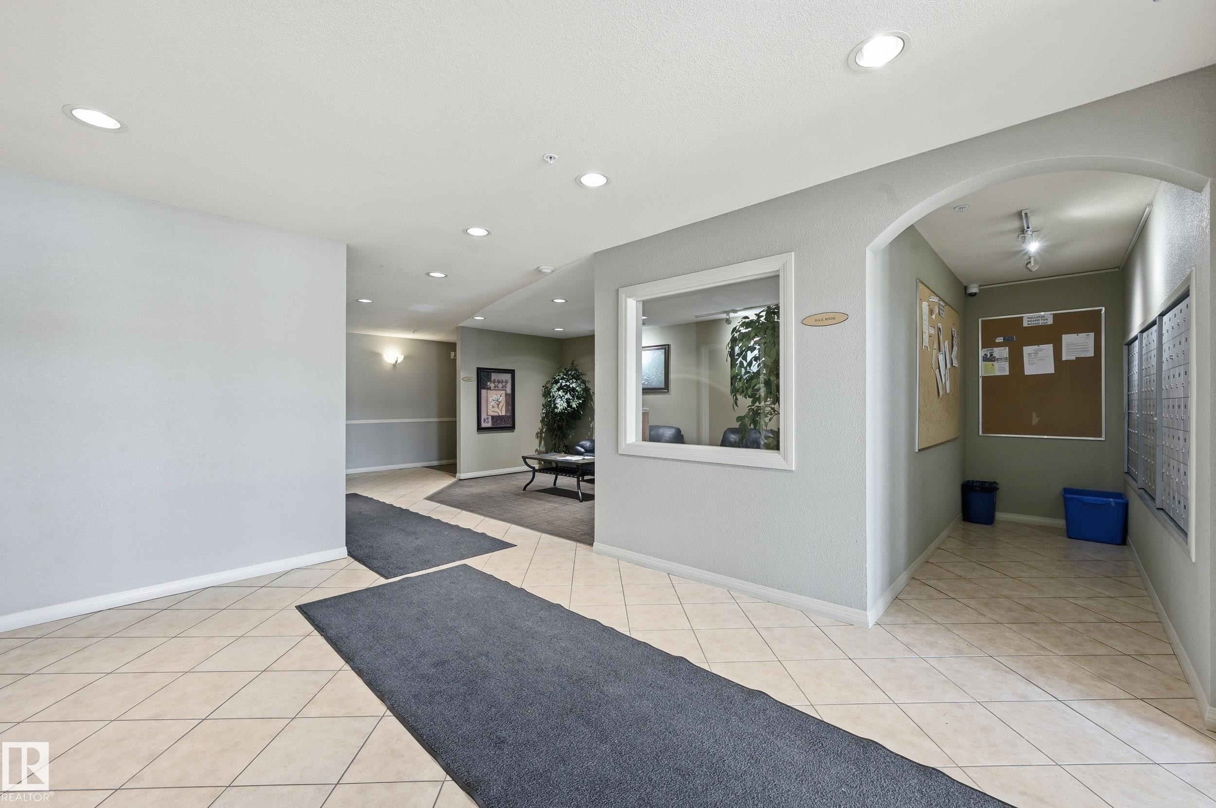 The property features a well-lit entrance area with recessed lighting and tiled flooring - 314 2430 Guardian Road, Edmonton, AB - Indoor Photo Showing Other Room