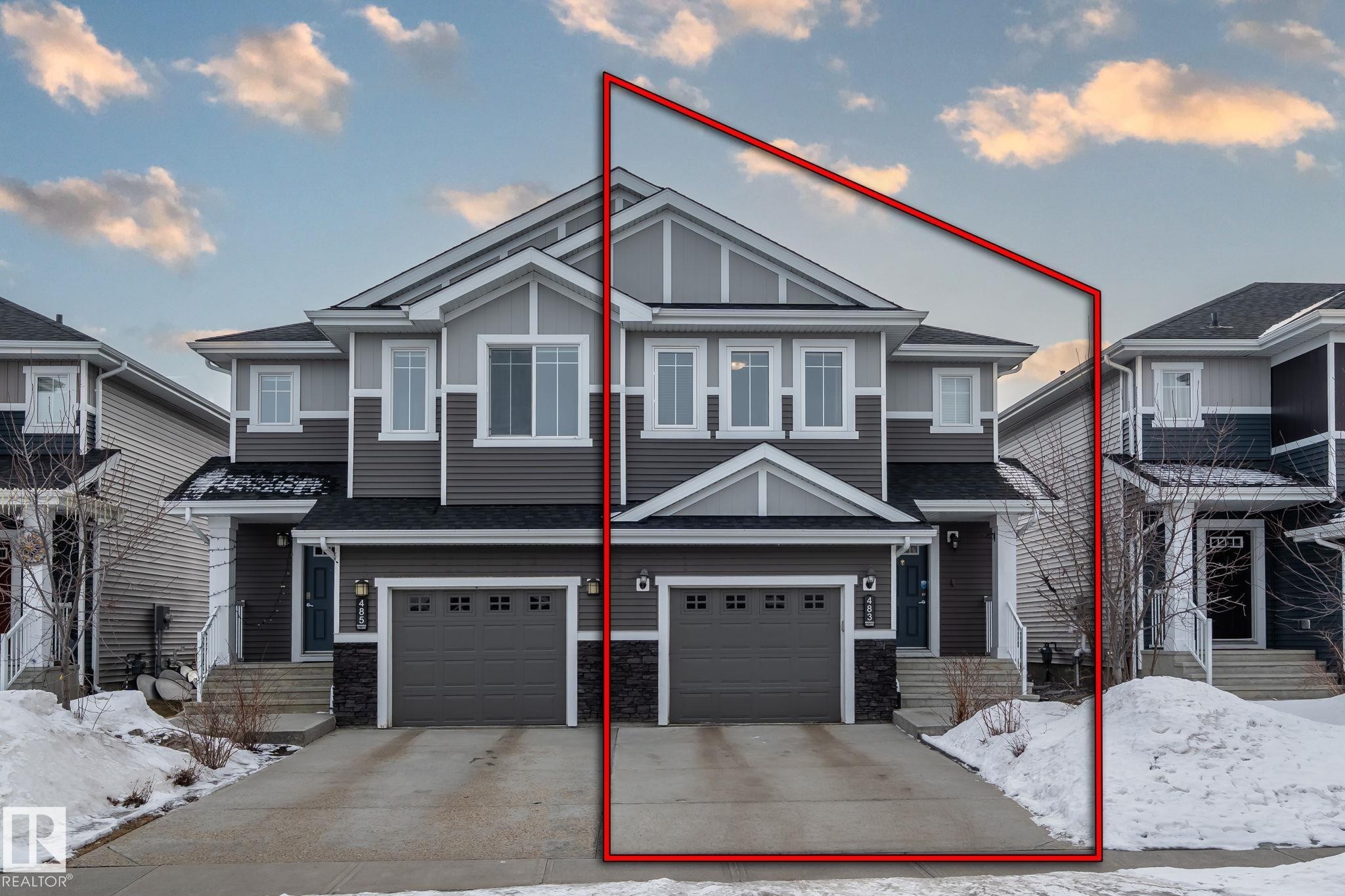 The property features a two-story facade with grey siding, white window frames, and an attached single-car garage - 483 Ebbers Way Nw, Edmonton, AB - Outdoor With Facade