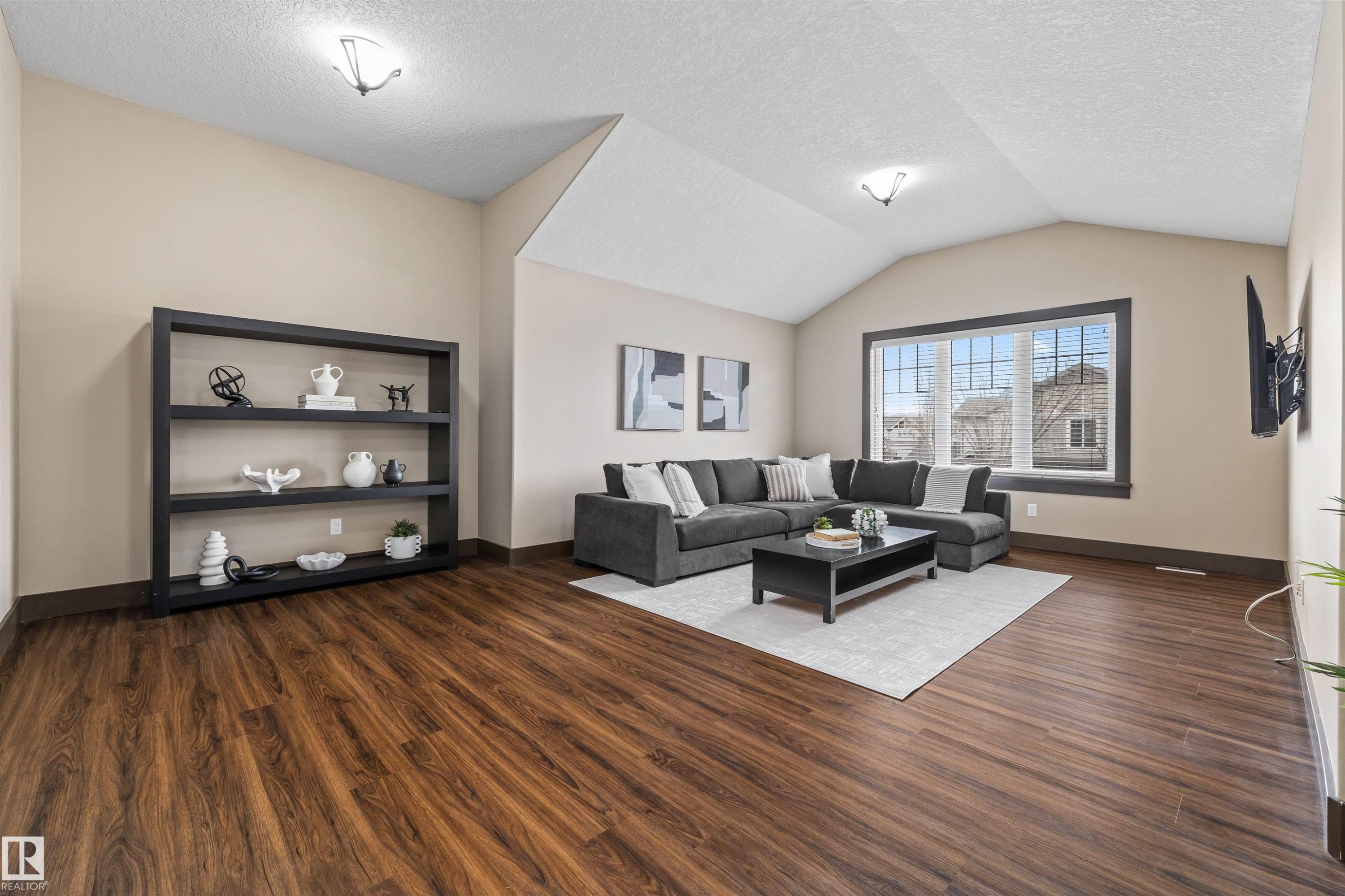 Family Room featuring rich wood flooring, vaulted ceilings, and large windows providing natural light - 1014 Hope Road, Edmonton, AB - Indoor Photo Showing Living Room